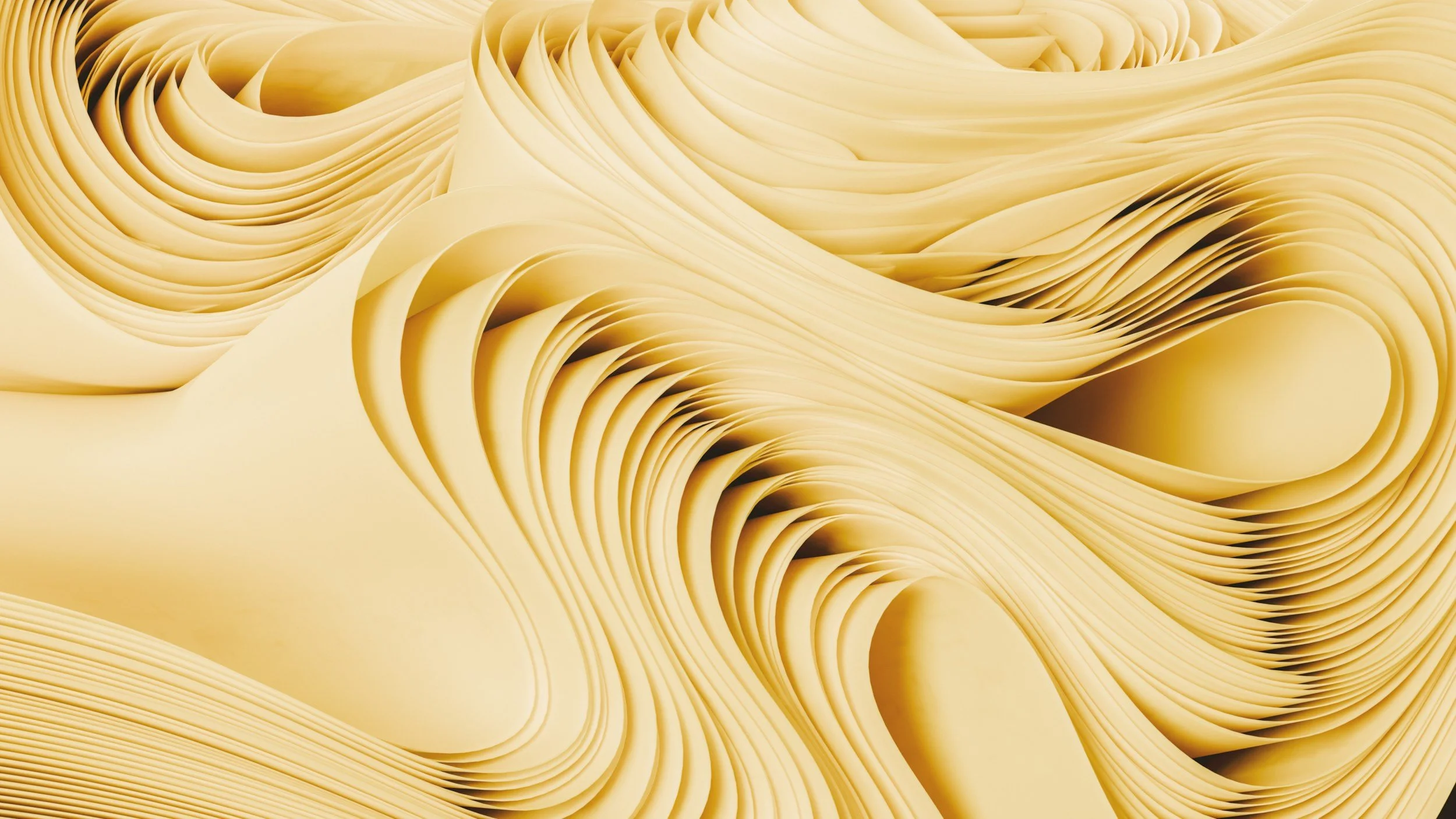 Close-up of several sheets of uncooked pasta, arranged in a swirling pattern.