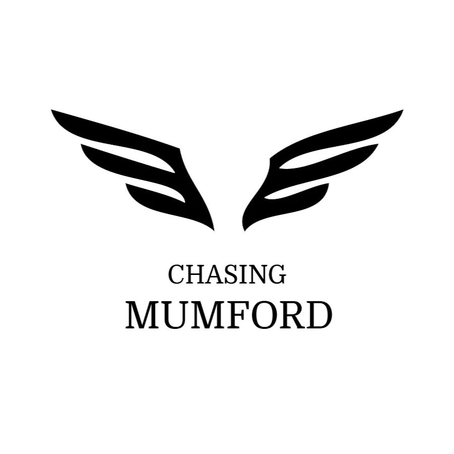 Black stylized angel wings with the text "Chasing Mumford" below, in black on a white background.