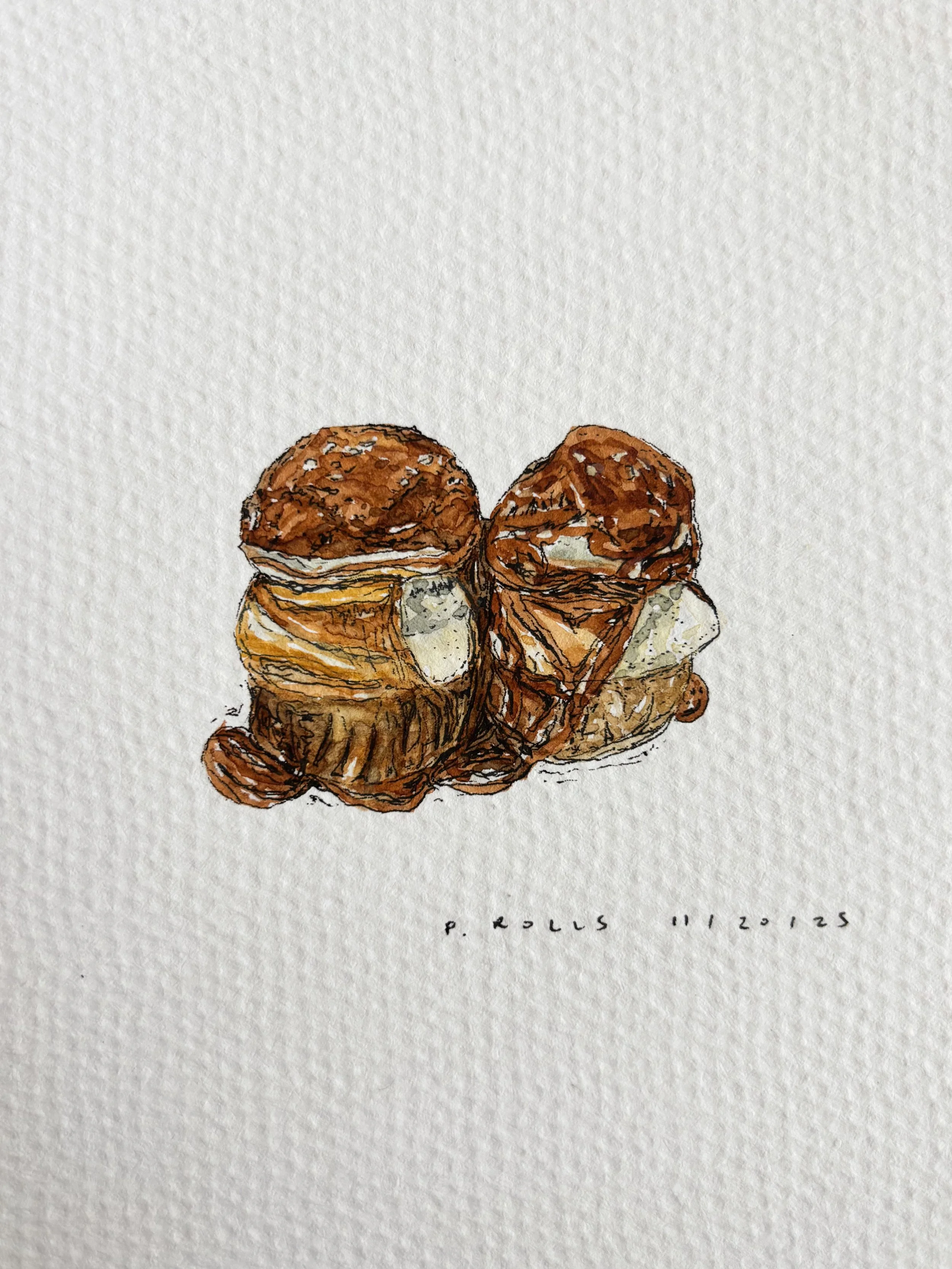 Watercolor painting of two cream puffs with chocolate topping against a white background, with handwritten text 'P. ROLL S 11/20/25' at the bottom.