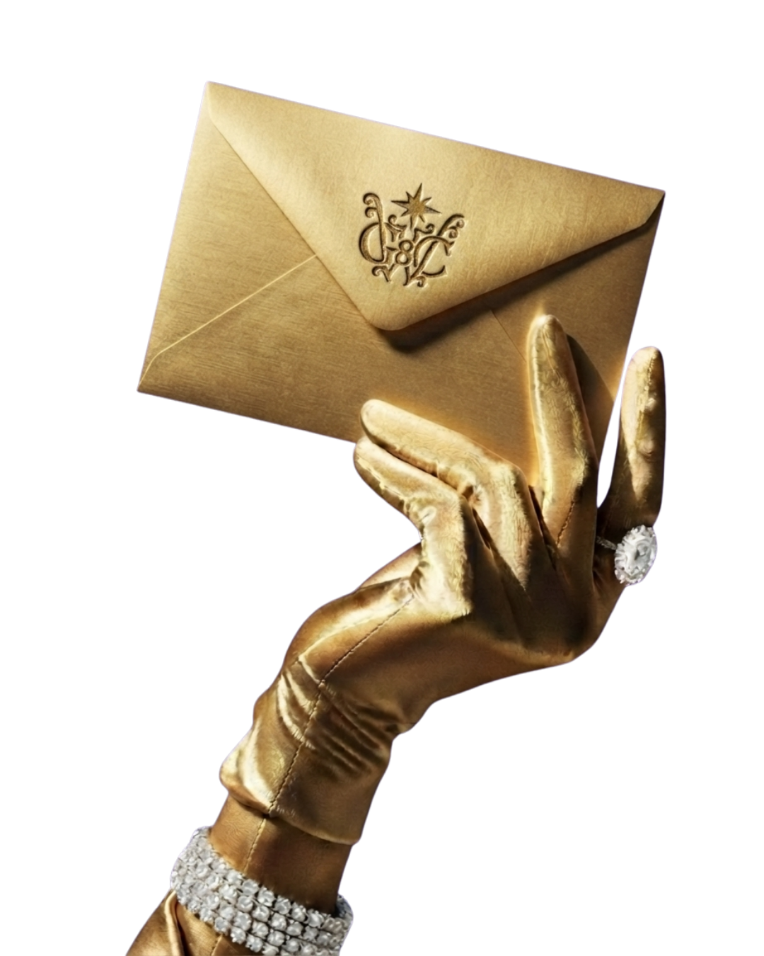 A hand in a gold satin glove and diamond ring holds up the gold GWC Golden Envelope sealed with the Good Woman Circle monogram