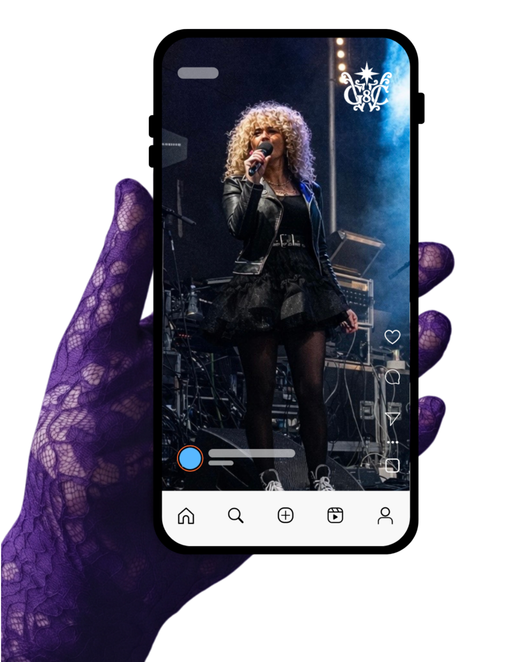 A hand in a purple lace glove holds a phone showing a woman with curly blonde hair singing on stage