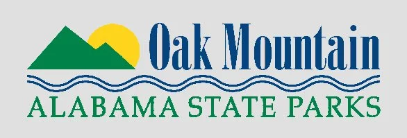 Logo for Oak Mountain Alabama State Parks featuring a mountain, sun, and water waves.