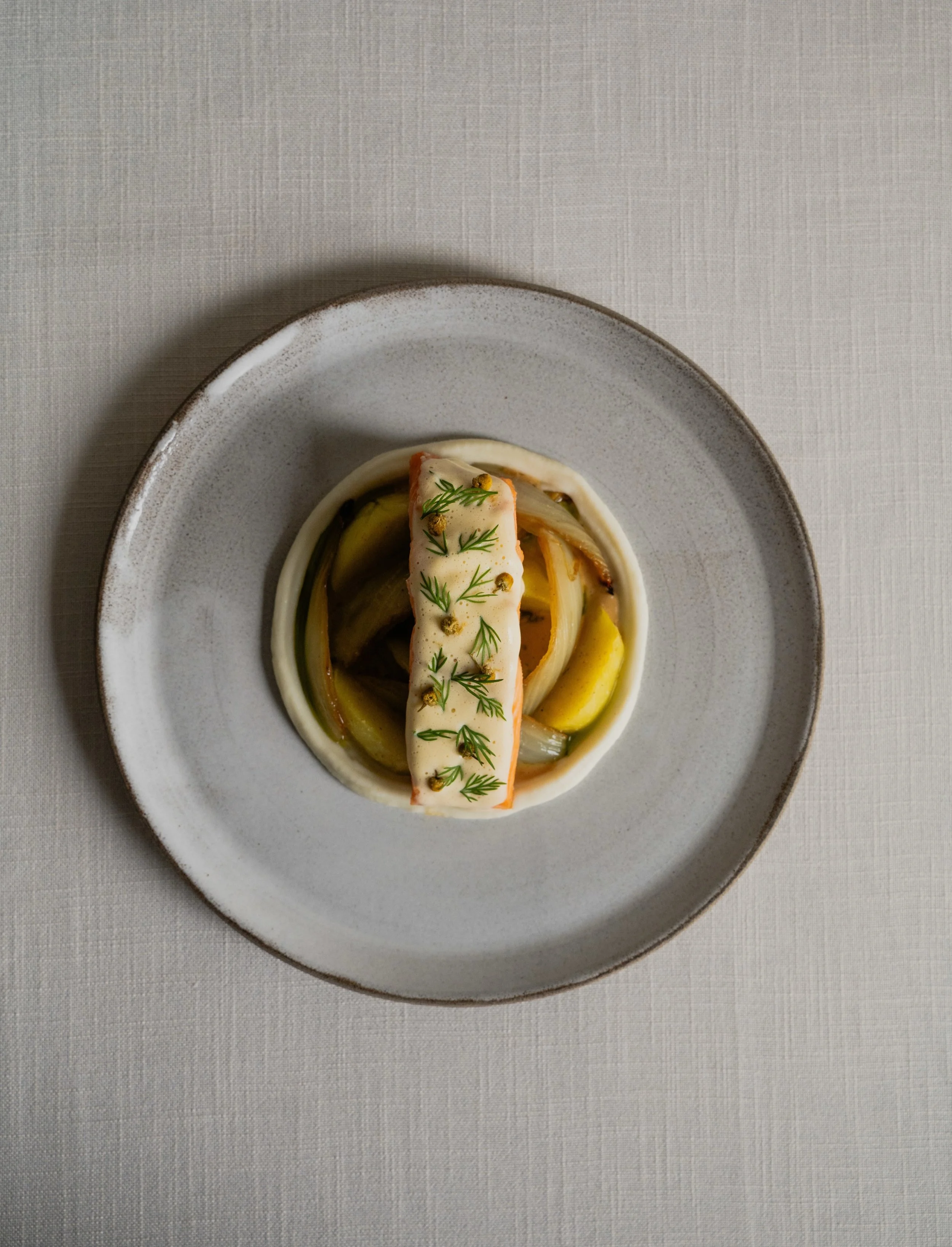 Salmon trout with braised fennel and chamomile hollandaise...

The salmon is paired with slowly braised fennel. A classic hollandaise sauce is infused with chamomile flowers, adding a gentle floral note to its rich, buttery character.

@Michelinguide