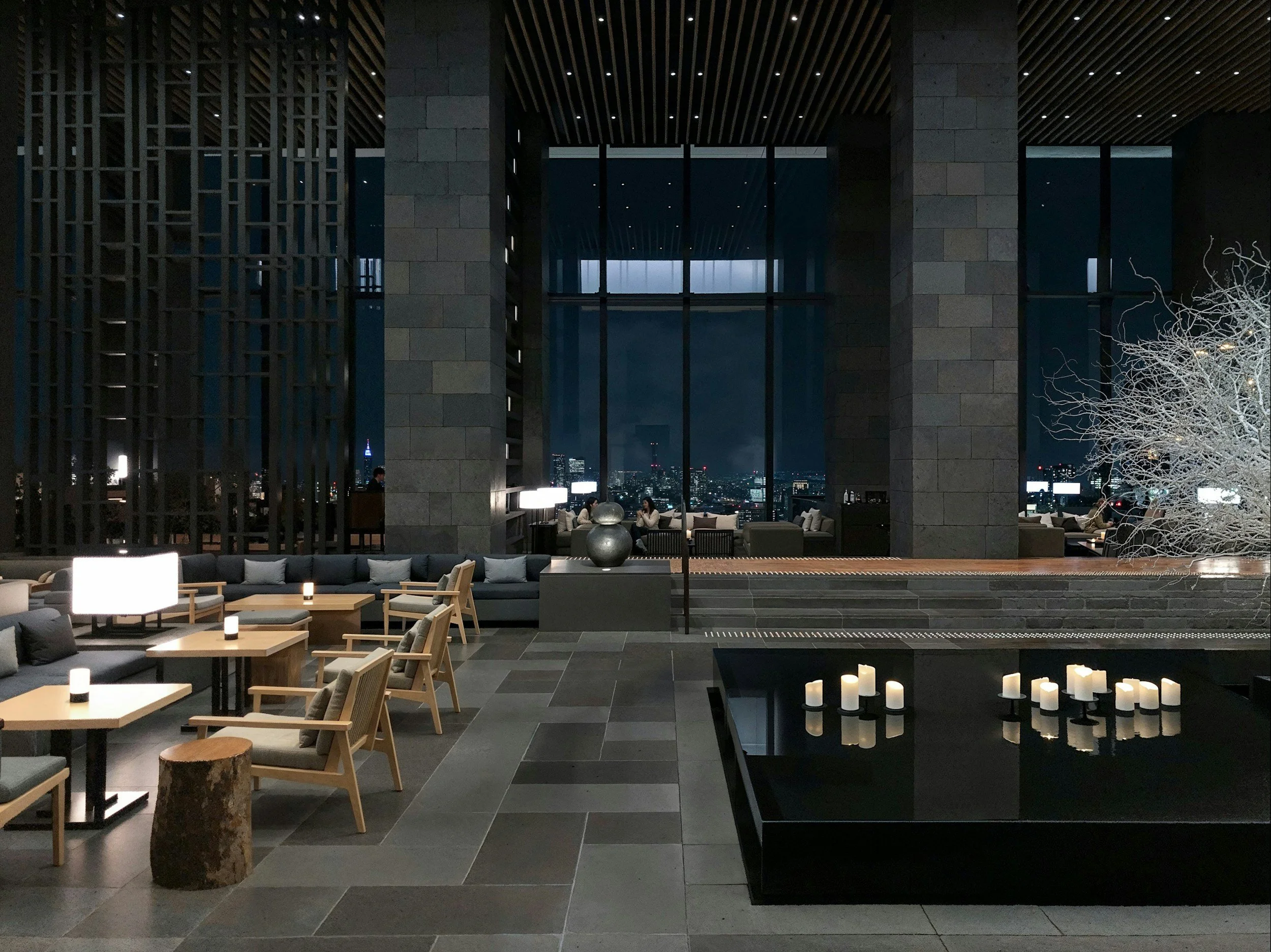 Luxury hotel lobby lounge at night overlooking the city skyline