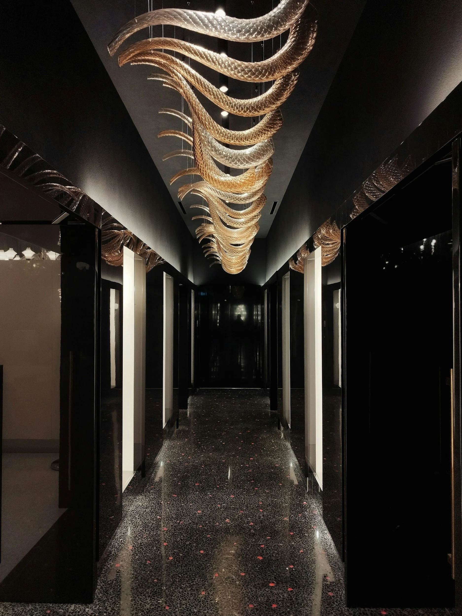 Luxury hotel corridor with sculptural chandelier, hotel asset management