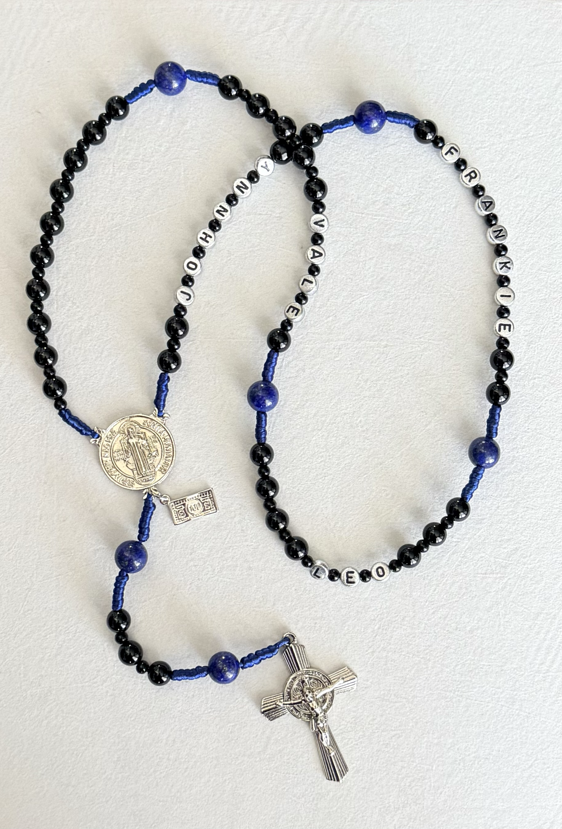 Beaded rosary with black and blue beads, silver medallions, and a silver crucifix.
