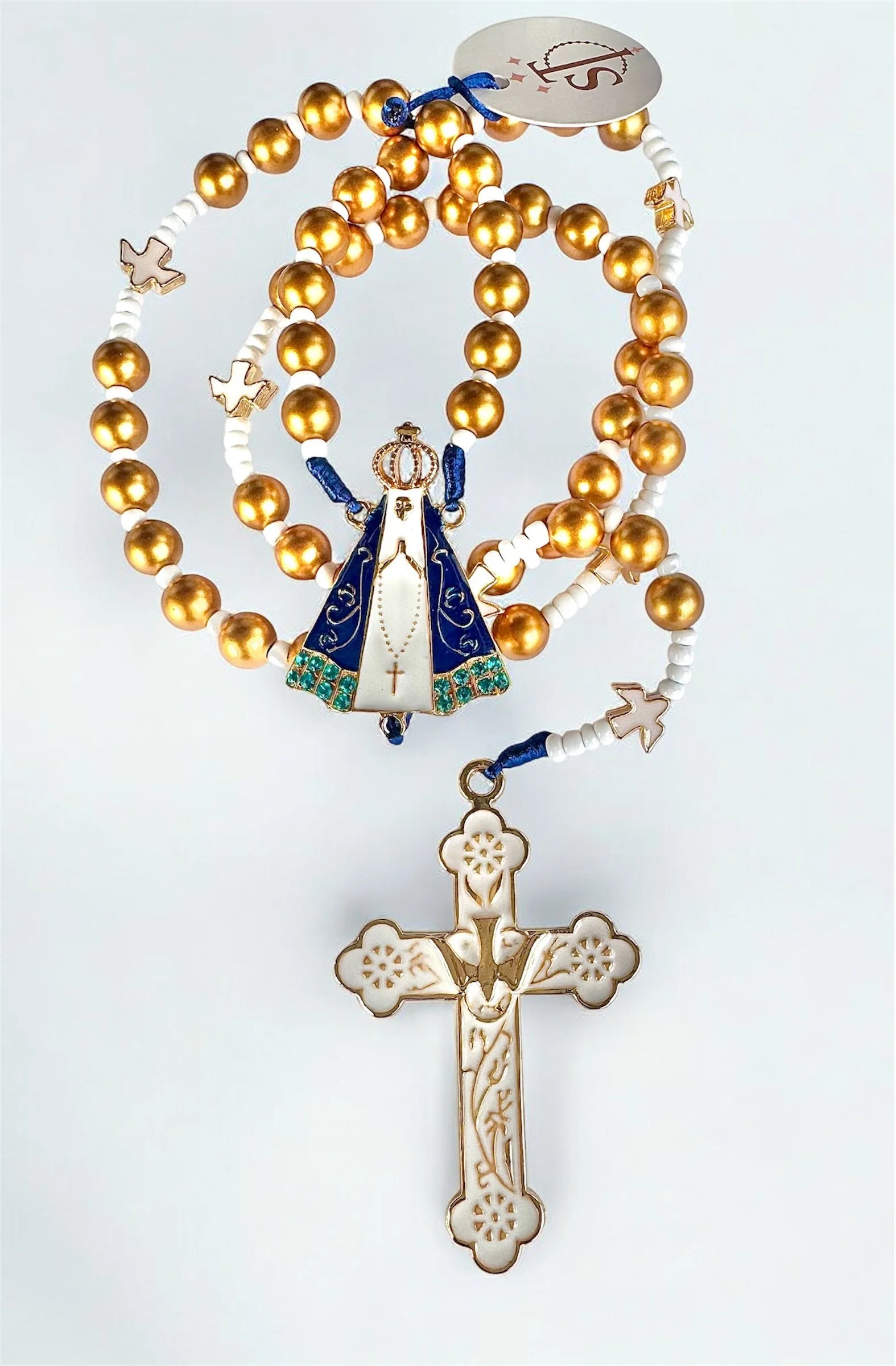 A religious rosary with gold beads, a blue cloak, a crown, a cross, and a white pendant depicting a religious figure, set against a white background.