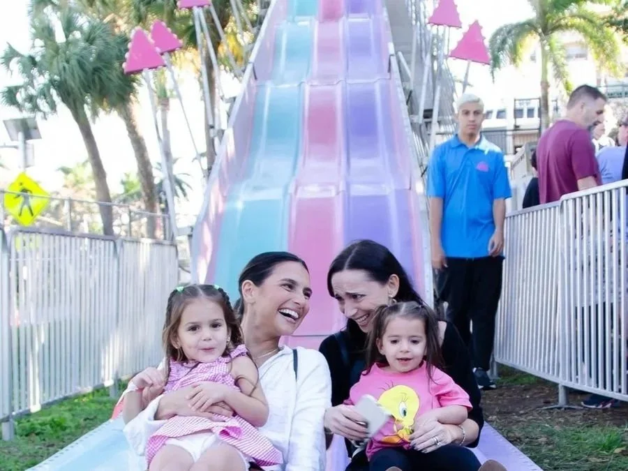 Family riding down a giant festival slide