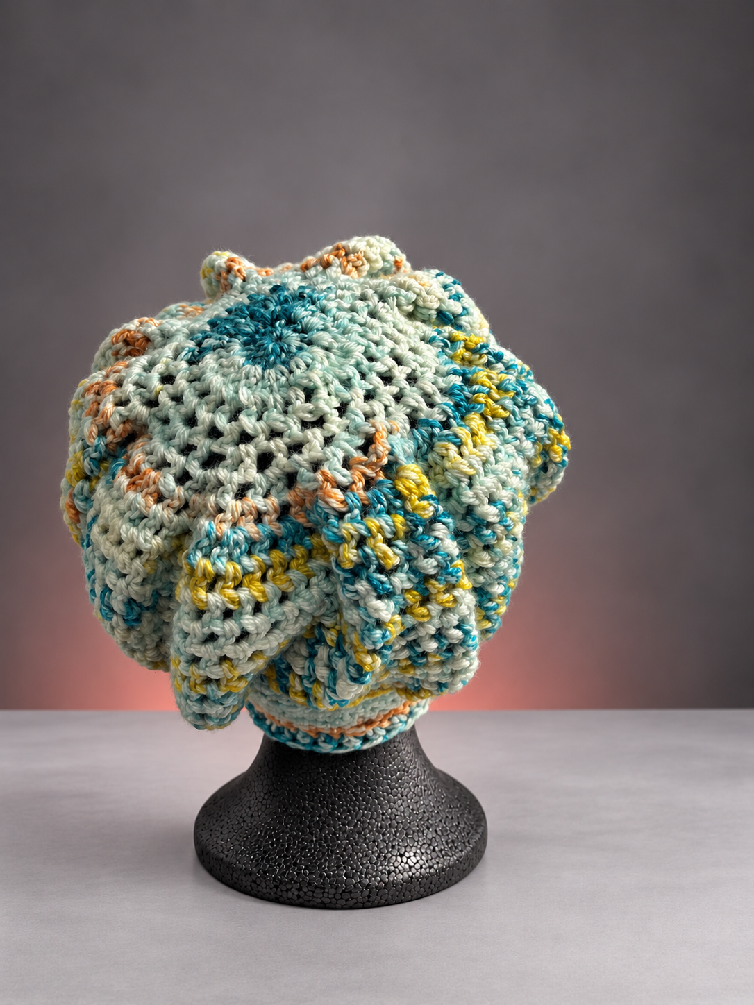 Handmade pastel crochet bonnet on mannequin-3.png