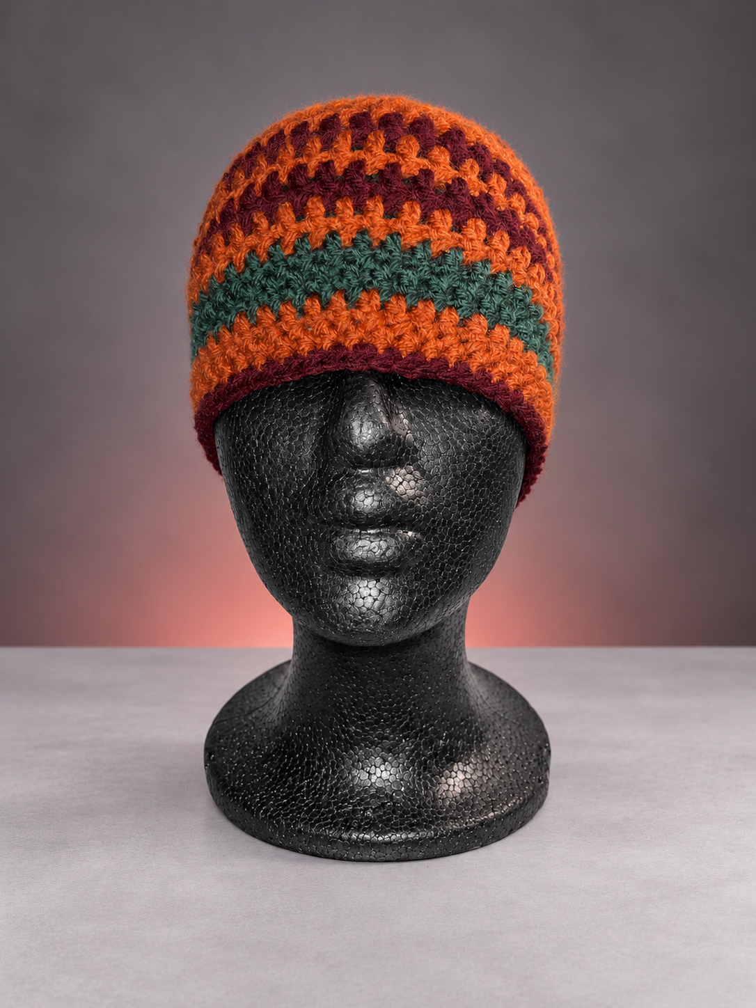 Rust, wine and green striped beanie.png