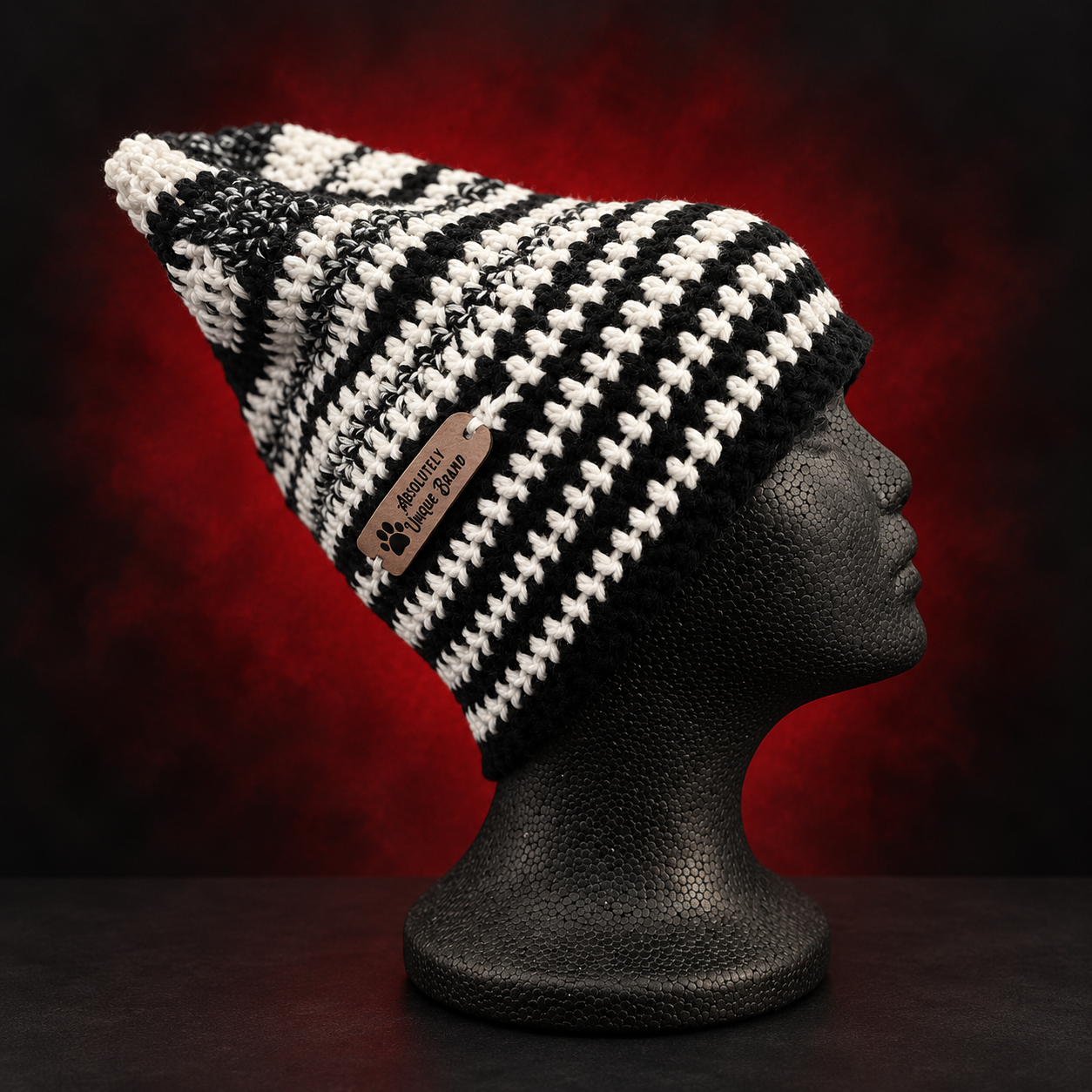 Handmade black-and-white crochet slouch beanie with the AUB tag. Wear it slouched or fold the brim for a shorter fit. One beanie, two ways to wear it. Crafted Different. Worn Bold.
