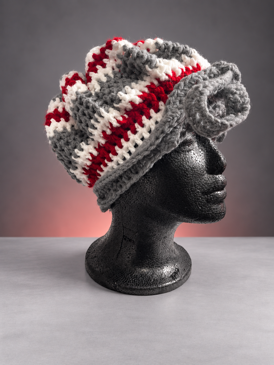 Handmade red, gray, and white crochet bonnet.png