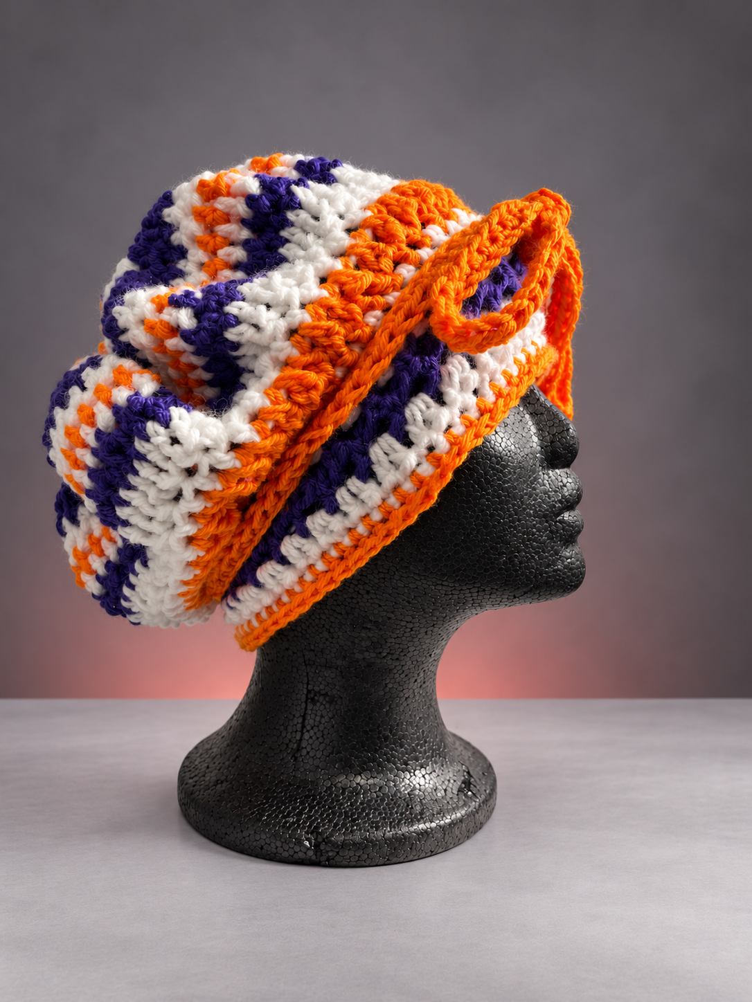 Handmade orange-purple crochet bonnet on mannequin-1.png