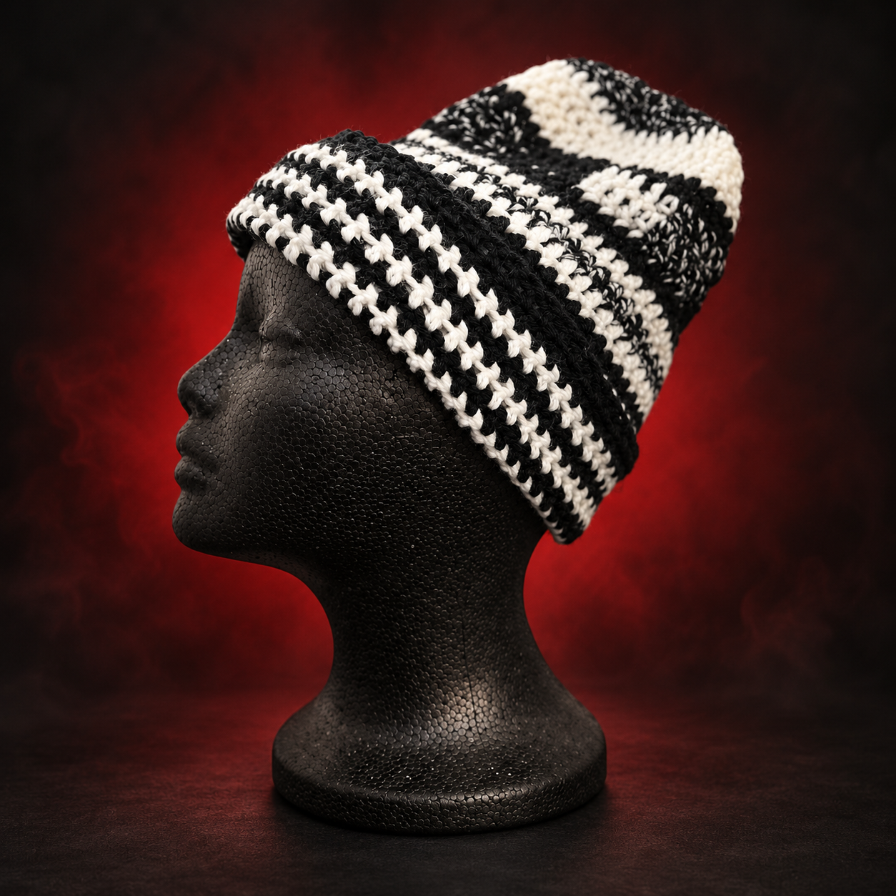 Handmade black-and-white crochet beanie shown with the brim folded for a shorter fit. Unfold it to wear it slouched—the same beanie, styled your way. Crafted Different. Worn Bold.