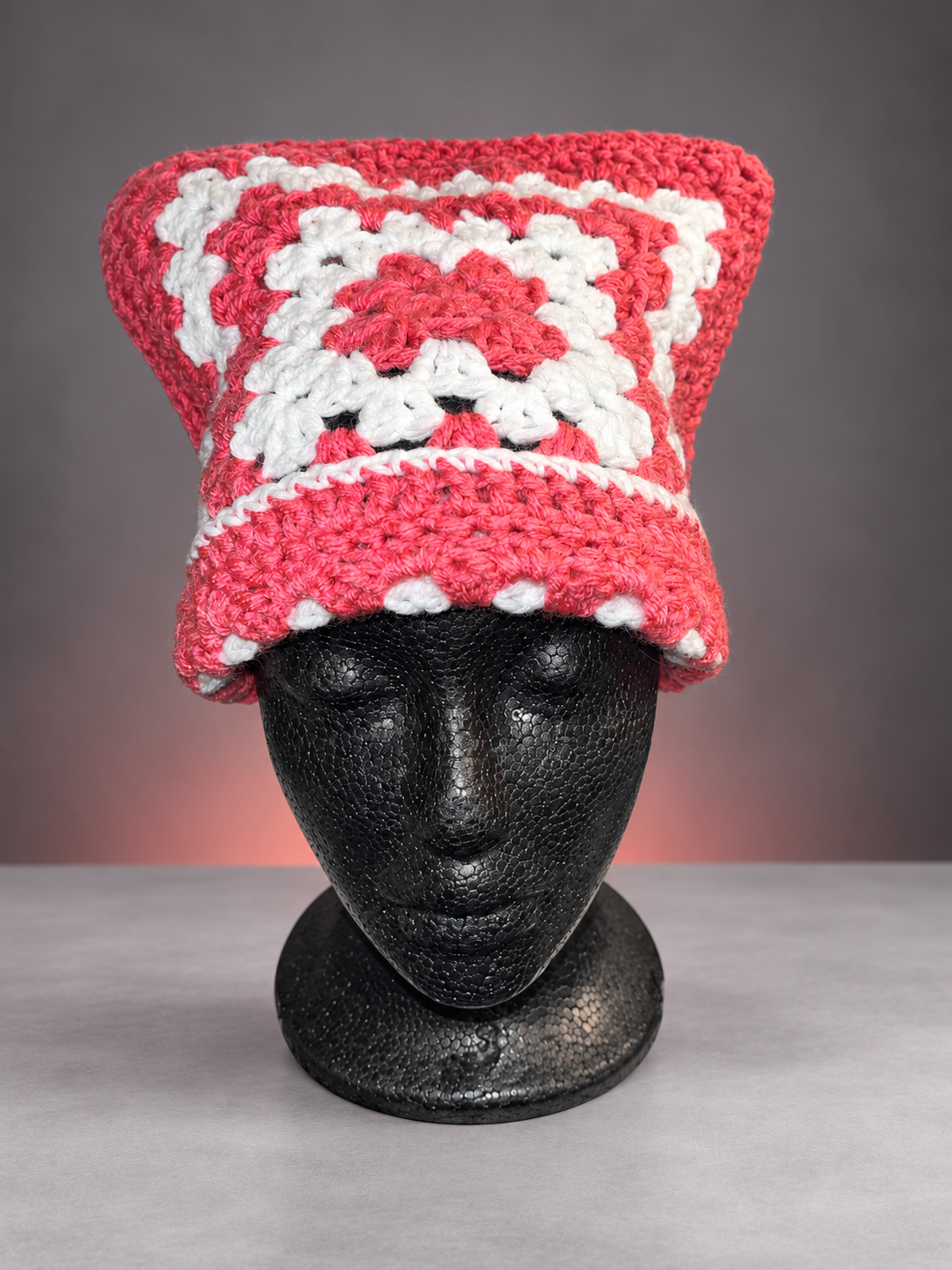 Pink-and-white crochet beanie on mannequin-1.png