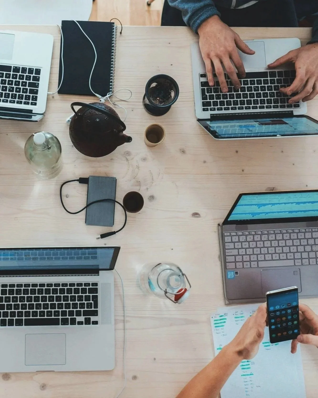 coworkers working at a table together with technology