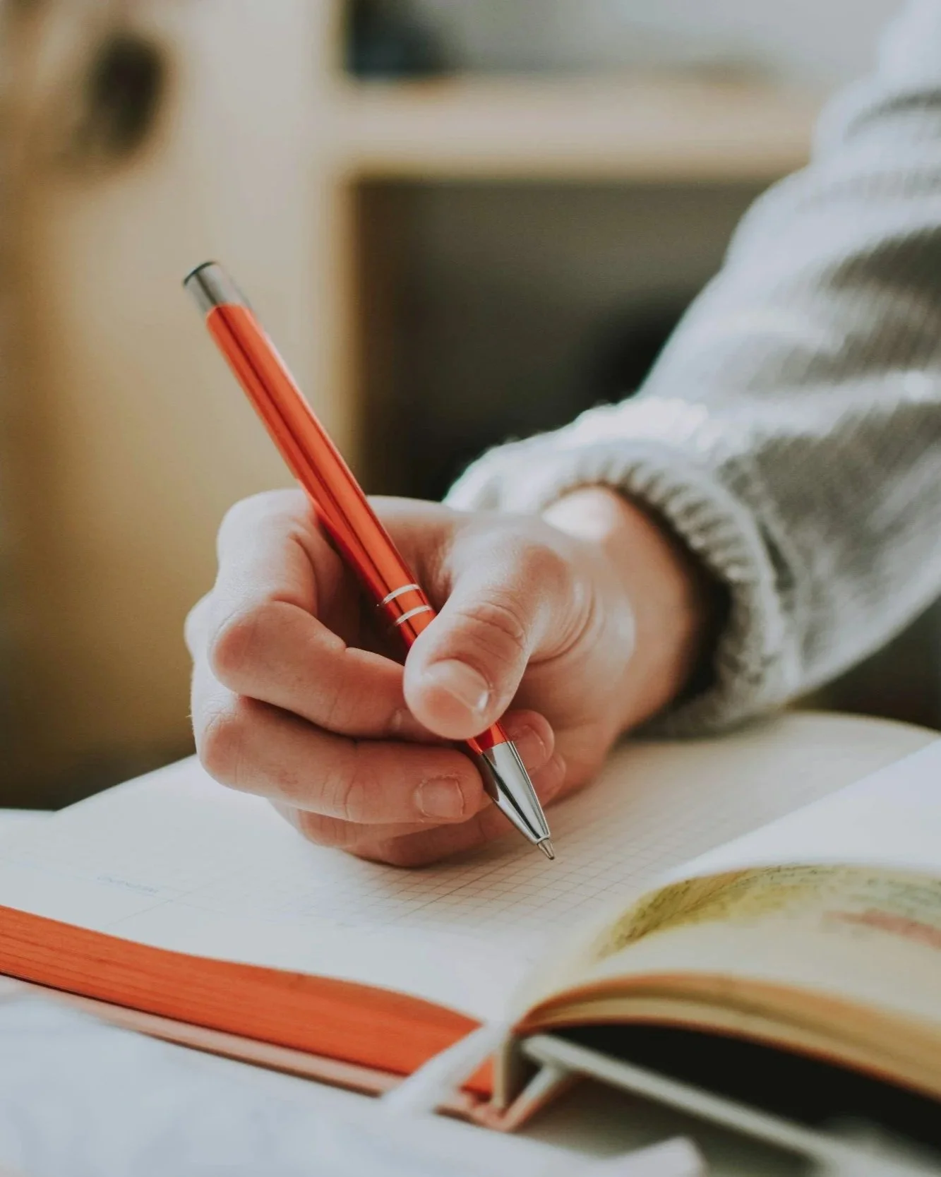 person writing in a notebook