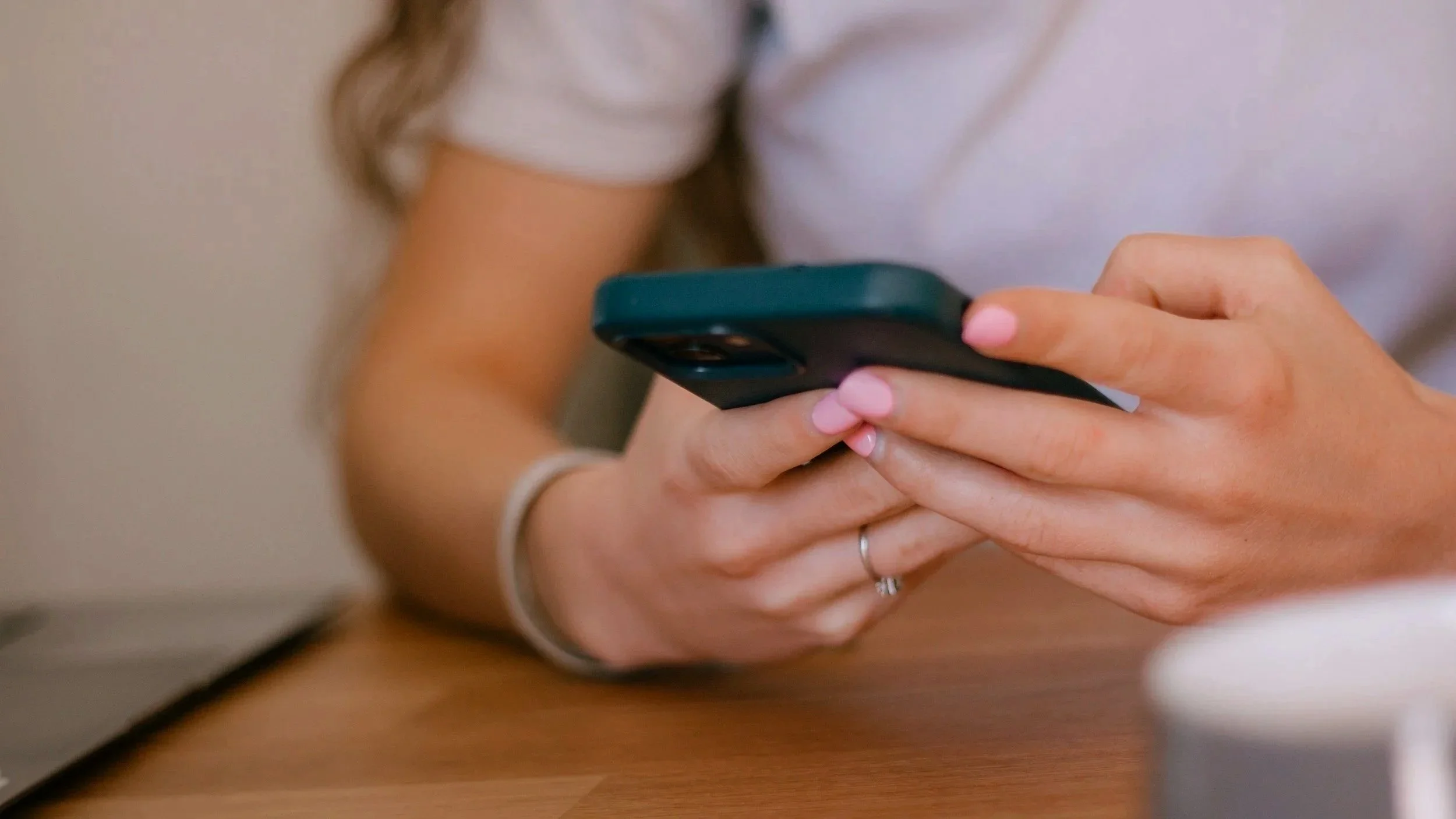 person typing on smart phone