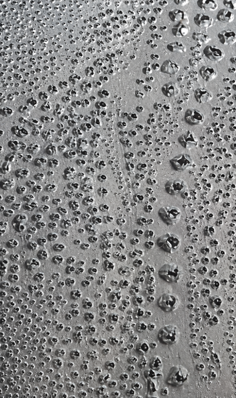 Close-up of portrait made up of dots through paper