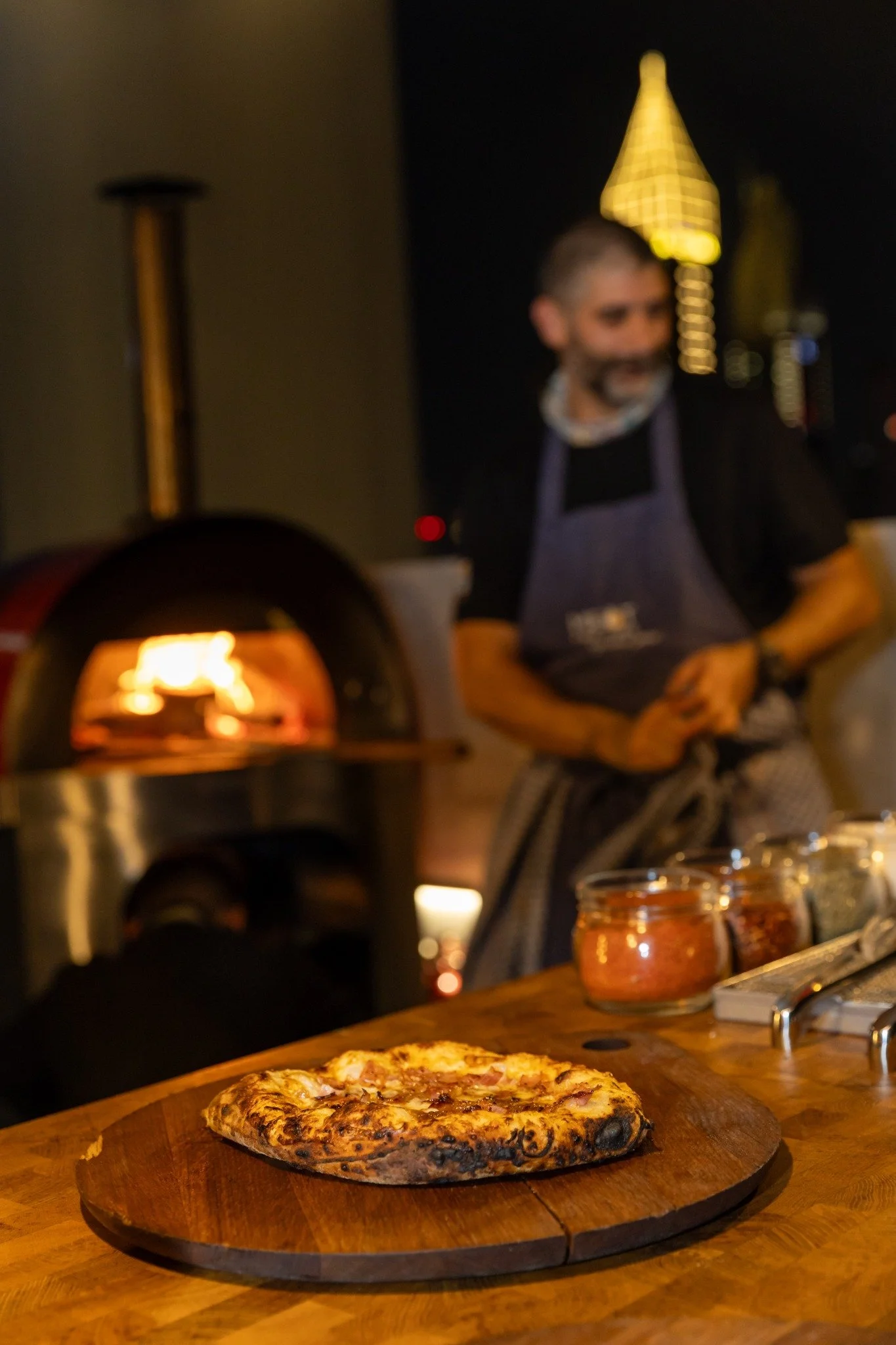 Bilal preparing pizza during an evening event.