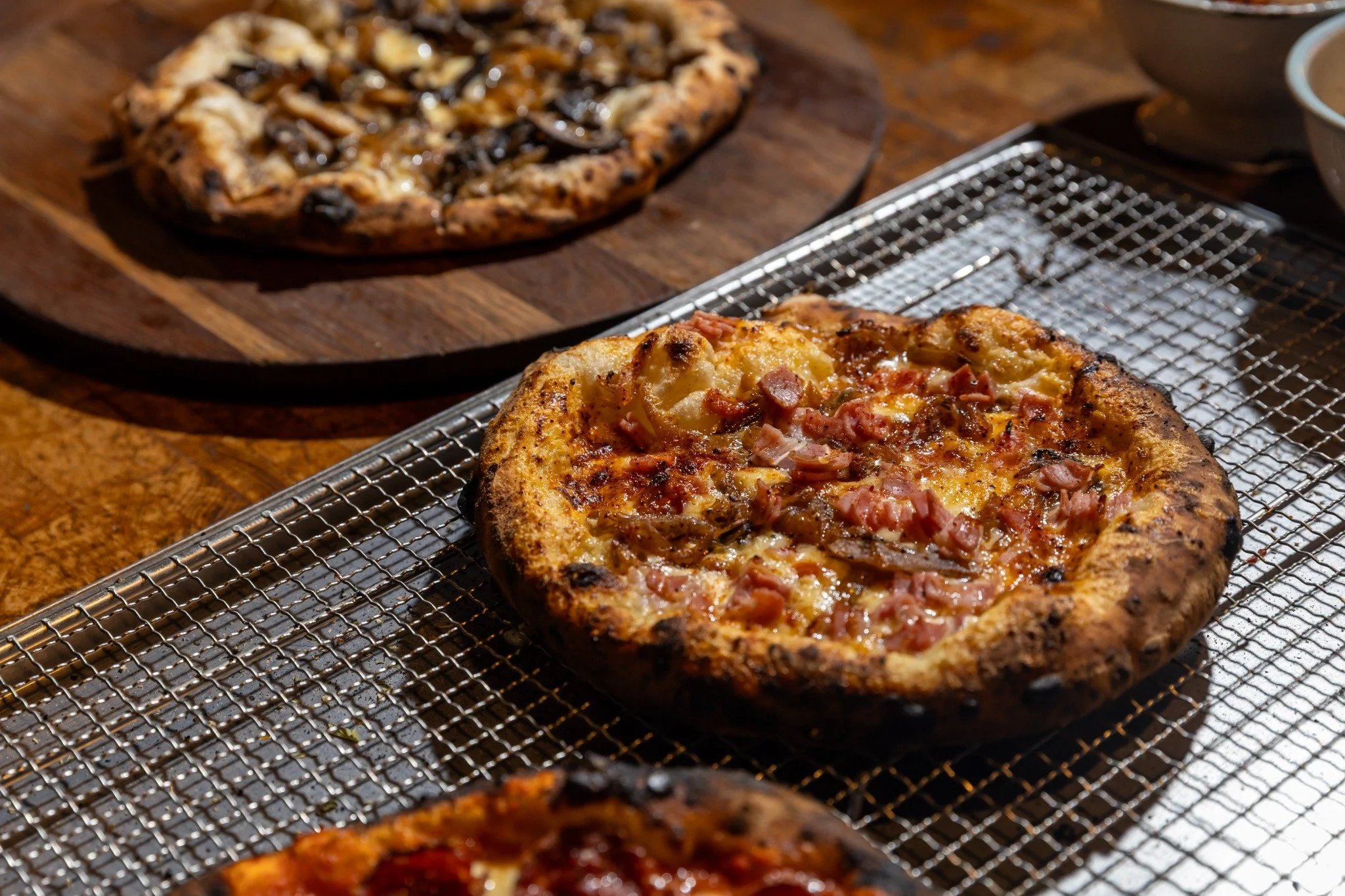 Freshly baked pizzas cooling after baking.