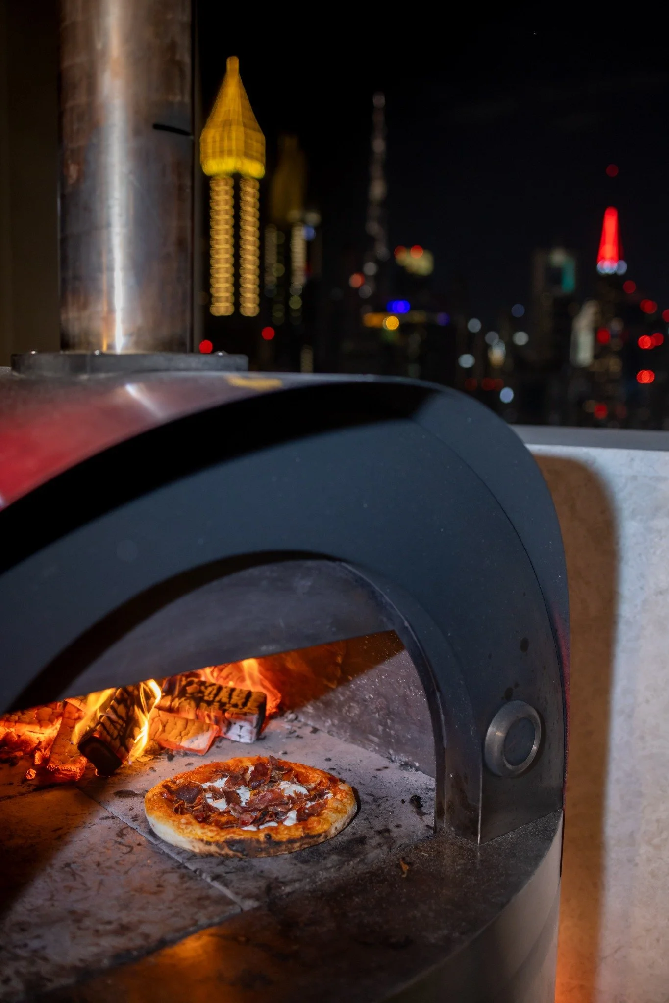 Wood-fired pizza oven in action.