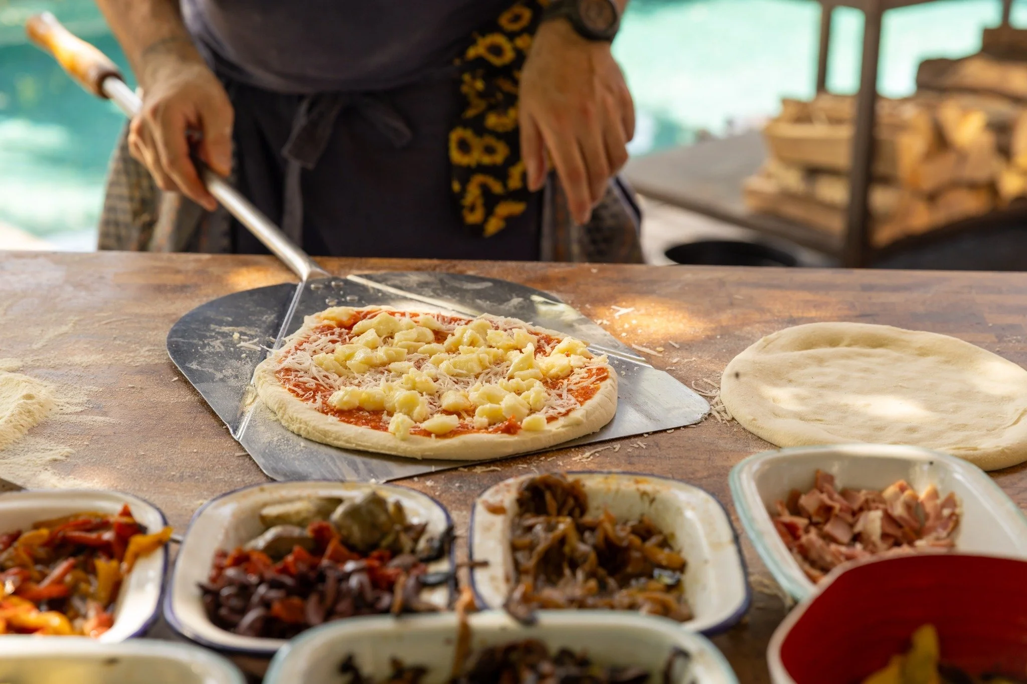 Preparing pizzas with a selection of fresh toppings.