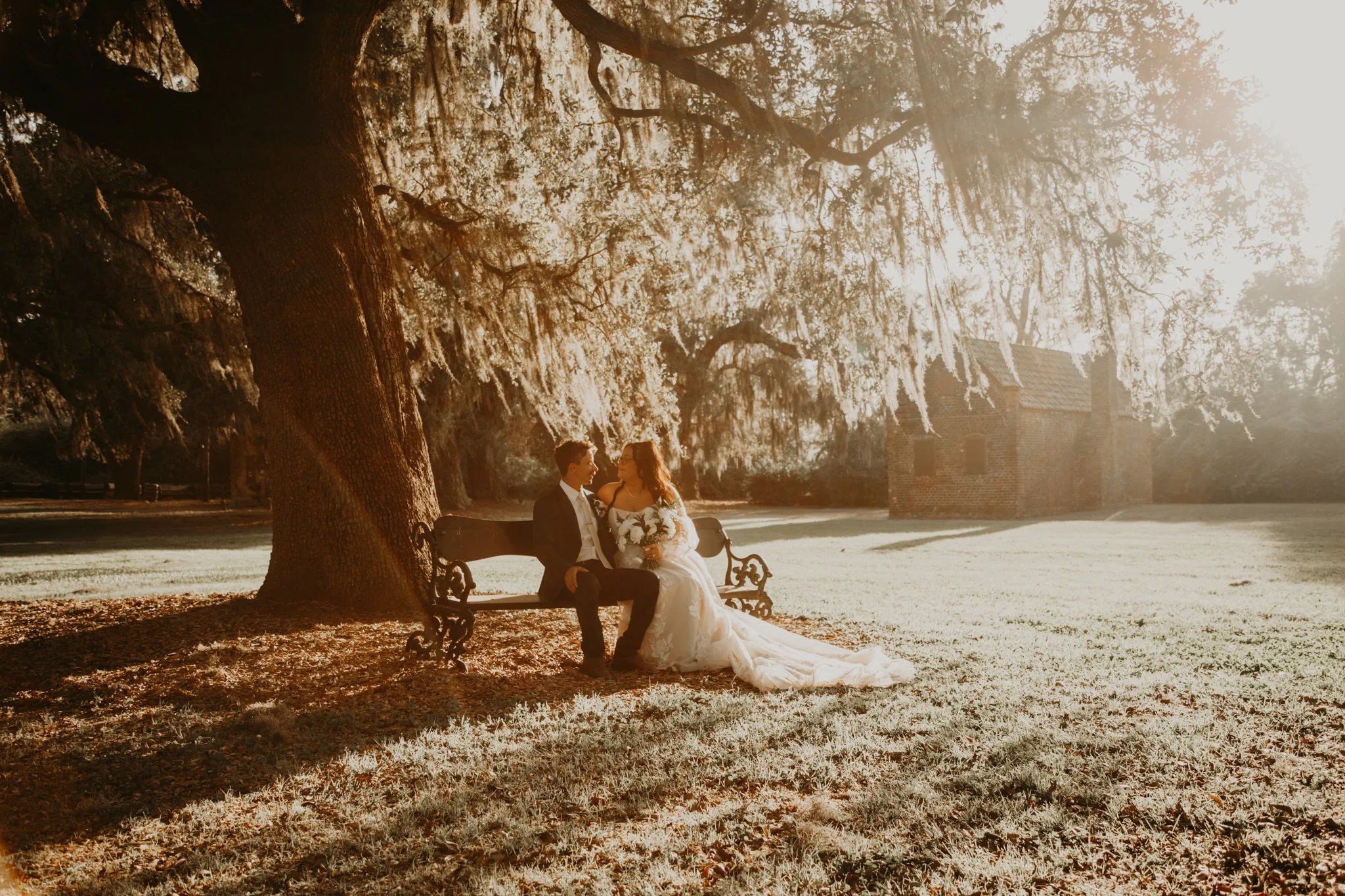 bride and groom sharing a moment on a bench