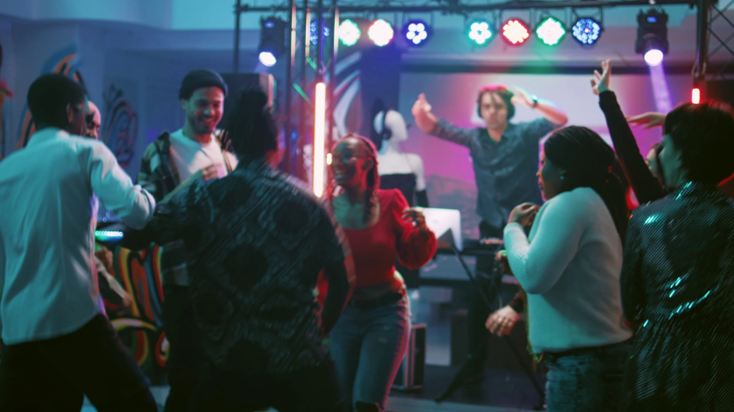 group-of-friends-enjoying-party-at-club-dancing-on-modern-music-and-jumping-on-dance-f-SBI-350046582.jpg