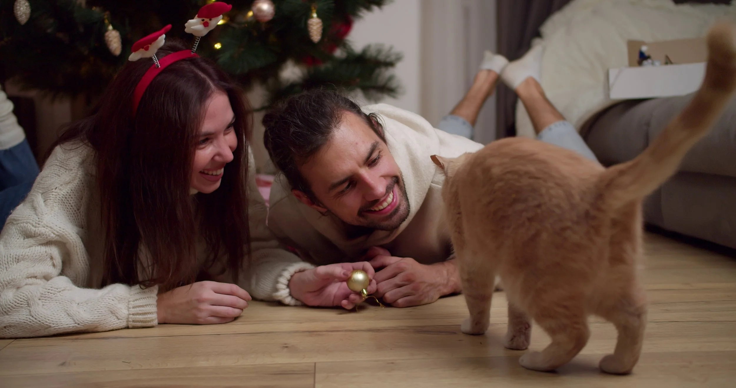 happy-young-couple-guy-and-girl-in-white-clothes-lie-on-the-floor-and-play-with-their--SBI-351032810.jpg