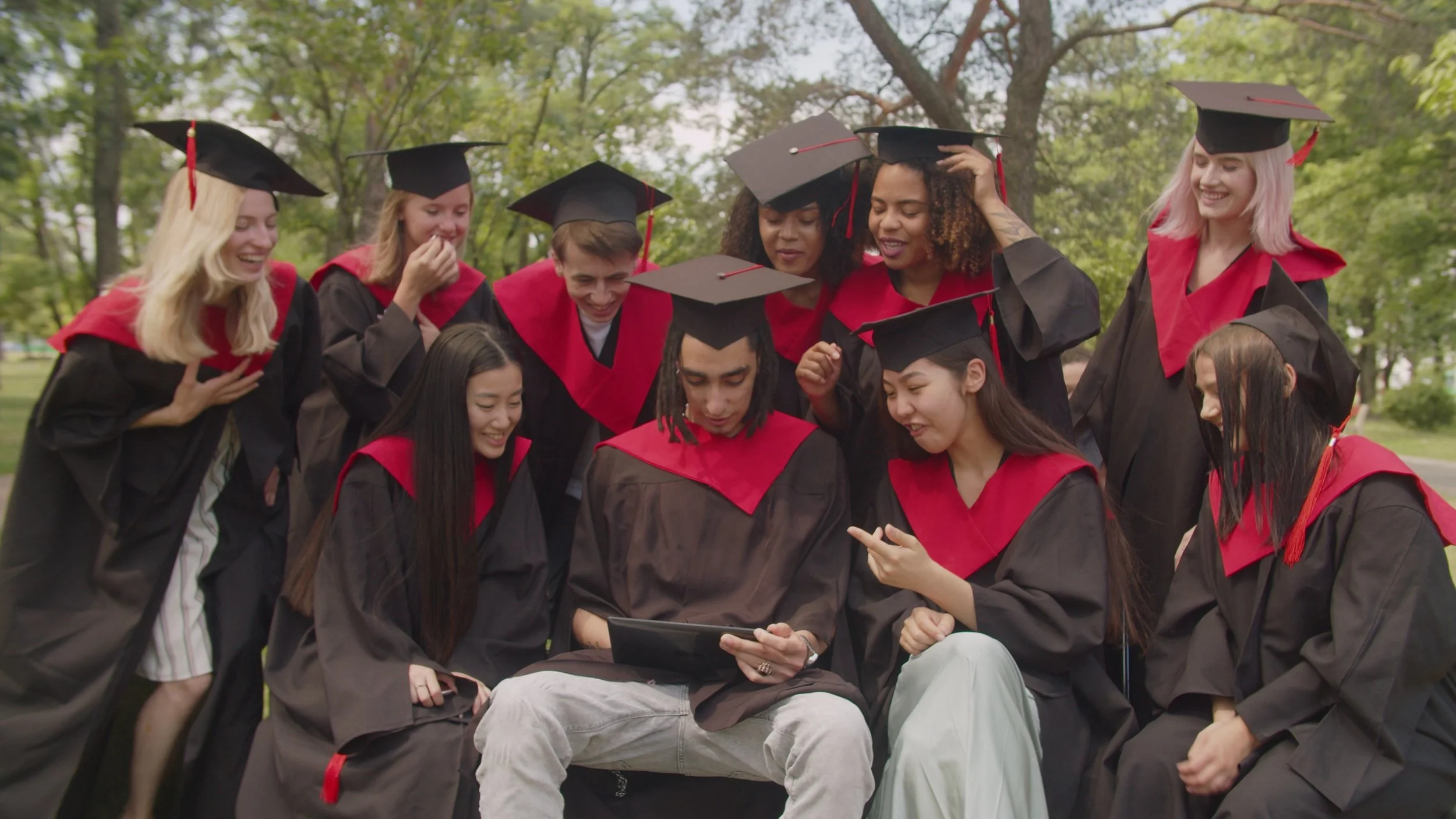 excited-carefree-diverse-multiracial-graduates-in-graduation-gowns-and-mortarboards-en-SBI-351571057.jpg