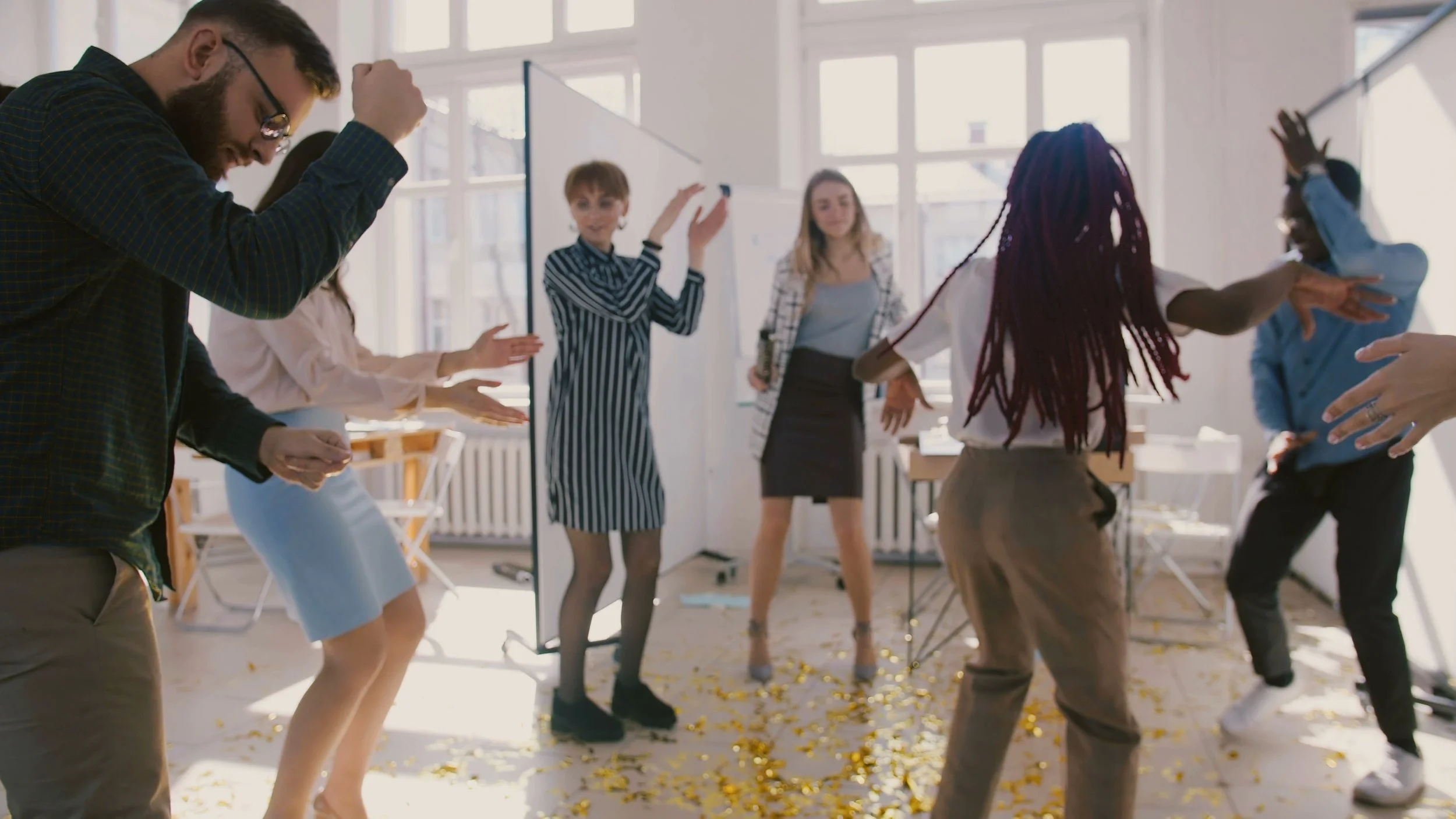 camera-moves-round-happy-multi-ethnic-business-people-relaxing-at-office-party-dancing-SBI-349502138.jpg