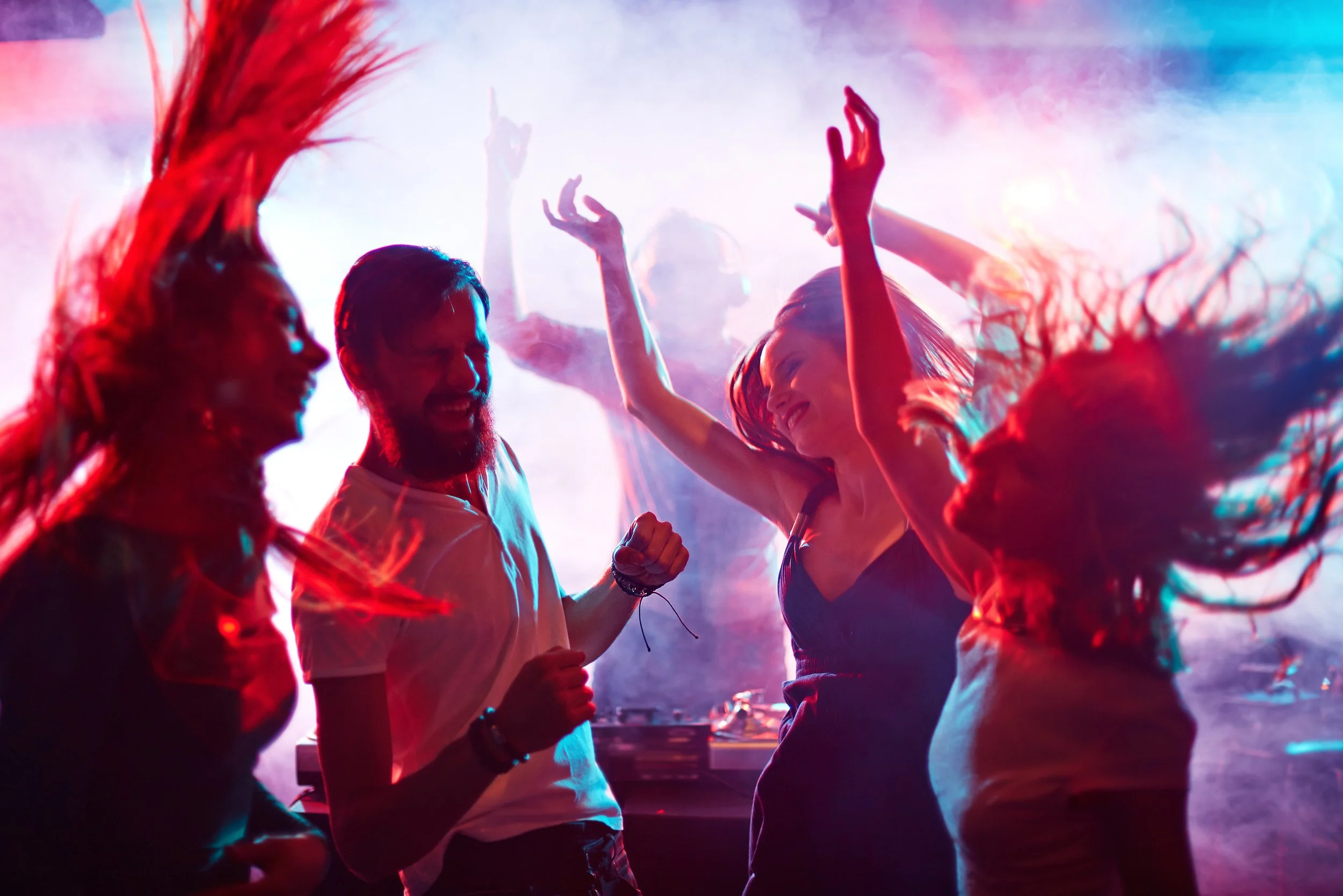group-of-energetic-friends-dancing-in-night-club-SBI-305520216.jpg