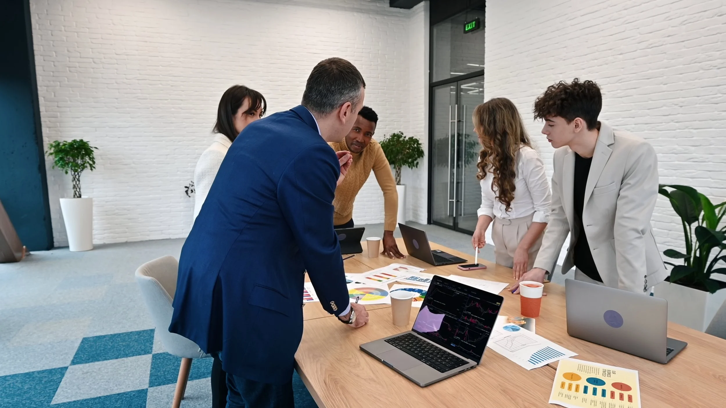 multiracial-group-of-people-at-business-meeting-in-an-office-discussing-business-affai-SBI-357442771.jpg