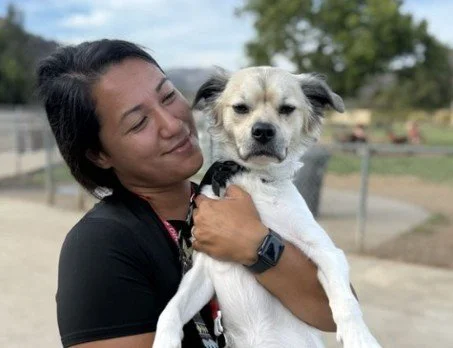 Woman holding white dog