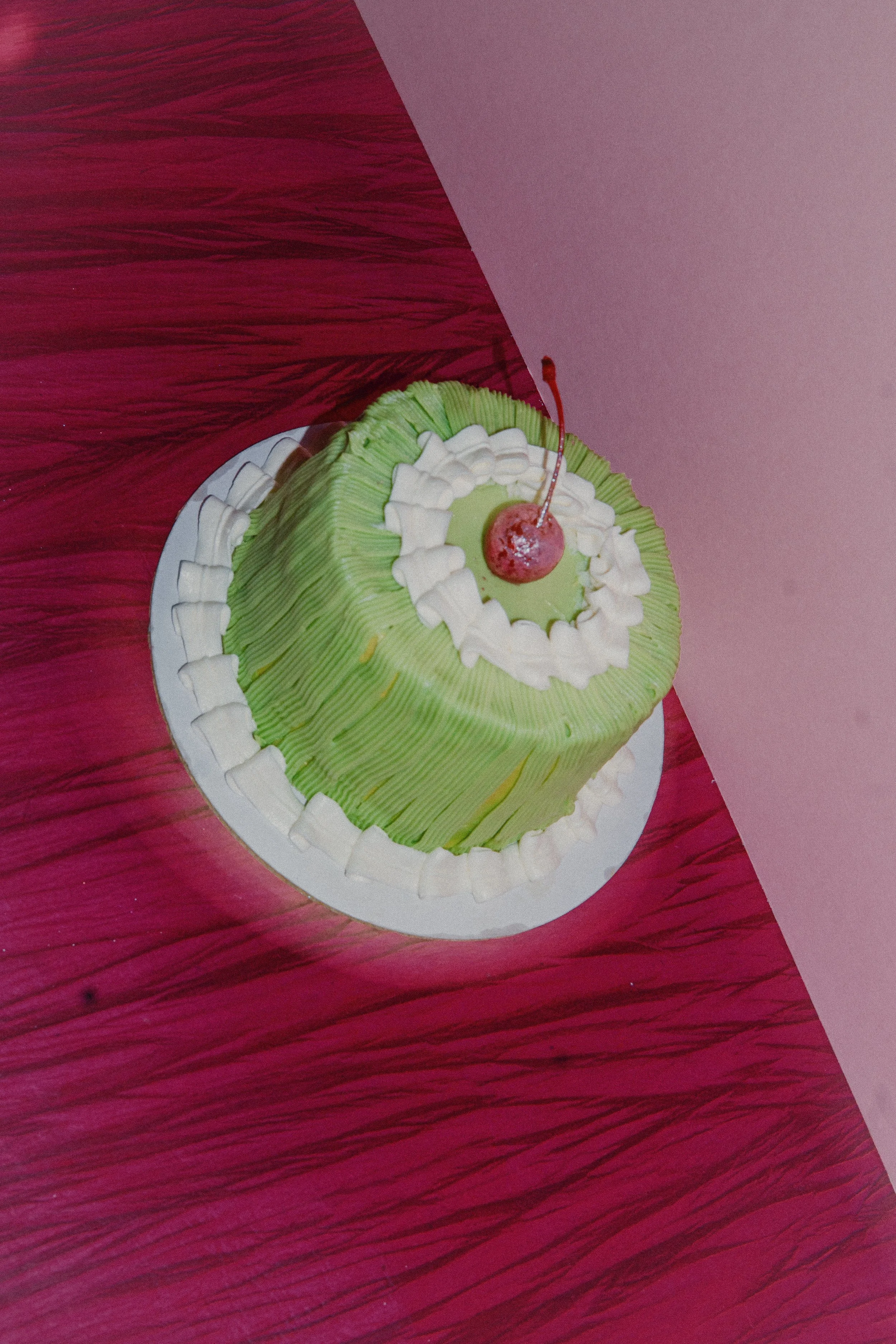 A vintage style custom cake with a pink glitter cherry on top. In Austin, Texas for cool parties.