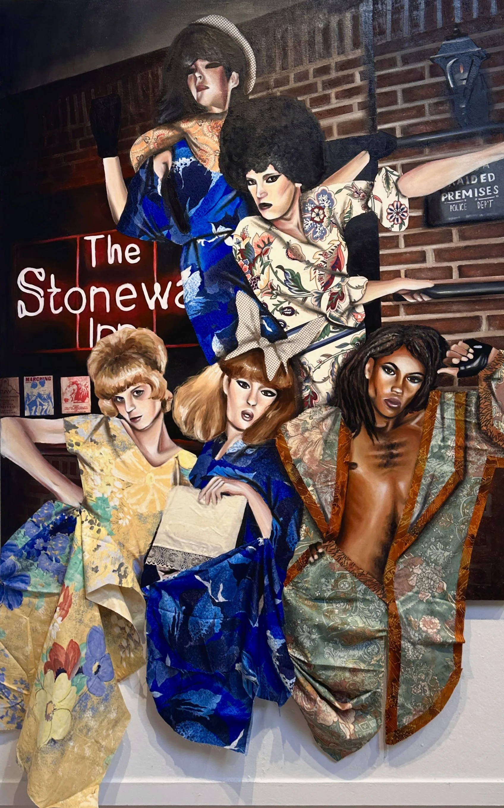 Mixed media artwork featuring diverse women in colorful traditional and modern clothing, set against a brick wall backdrop with a sign reading 'The Stonewall' and various posters.