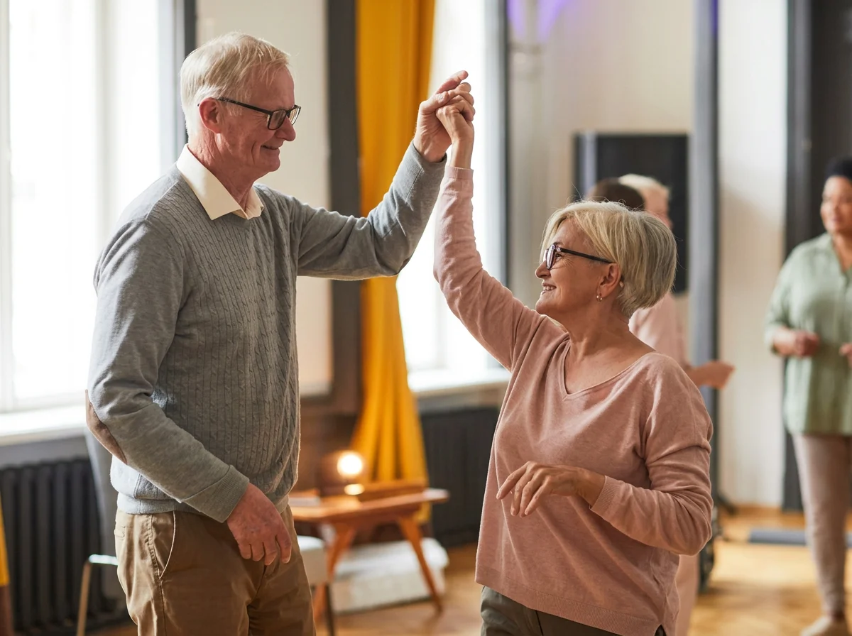 Older couple dancing together indoors while other adults socialize in the background