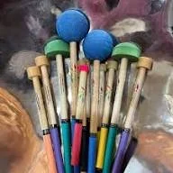 Set of steelpan sticks with different colours and sizes.