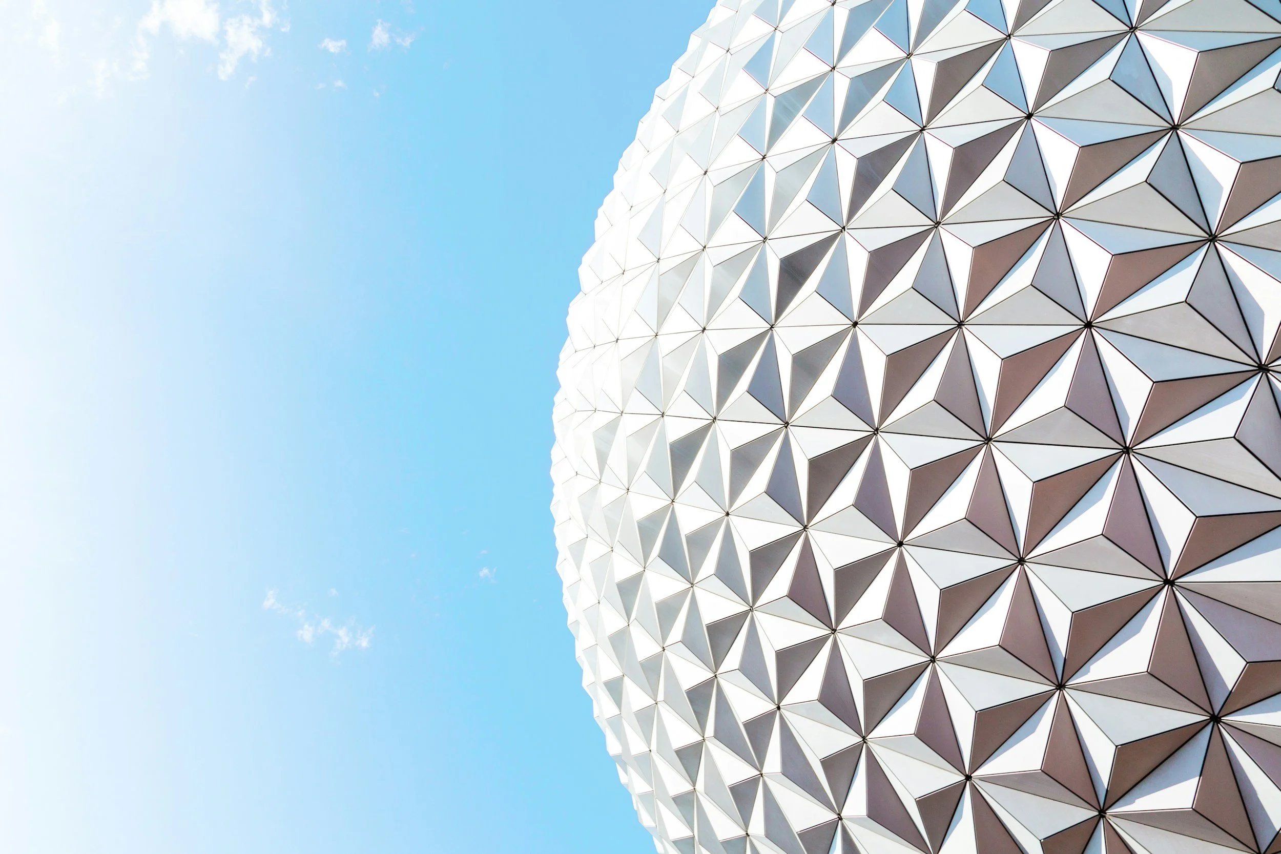 Close-up view of Geodesic Sphere at Epcot theme park, featuring white, triangular and diamond-shaped panels.
