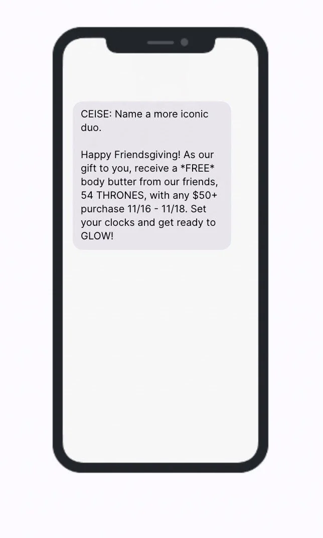 Text message on a smartphone screen promoting a Friendsgiving gift offer with free body butter from 54 THRONES for purchases over $50 between November 16 and November 18.