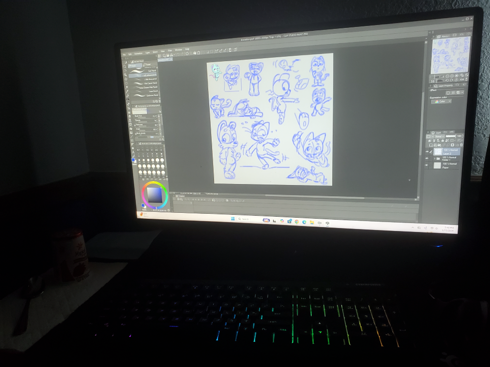 Computer monitor displaying digital sketches of cartoon characters in a drawing program, with a colorful backlit keyboard underneath.