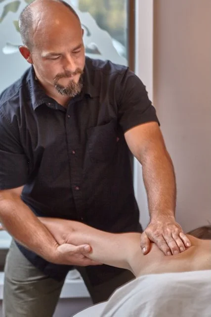 A man receiving a massage at a spa or massage therapy clinic.