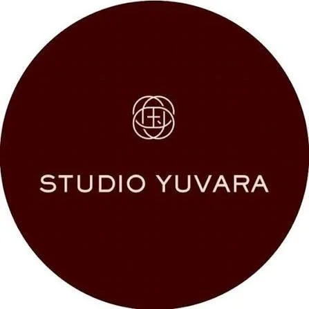 Black circular logo with a white geometric symbol at the top and the text 'STUDIO YUVARA' below it.
