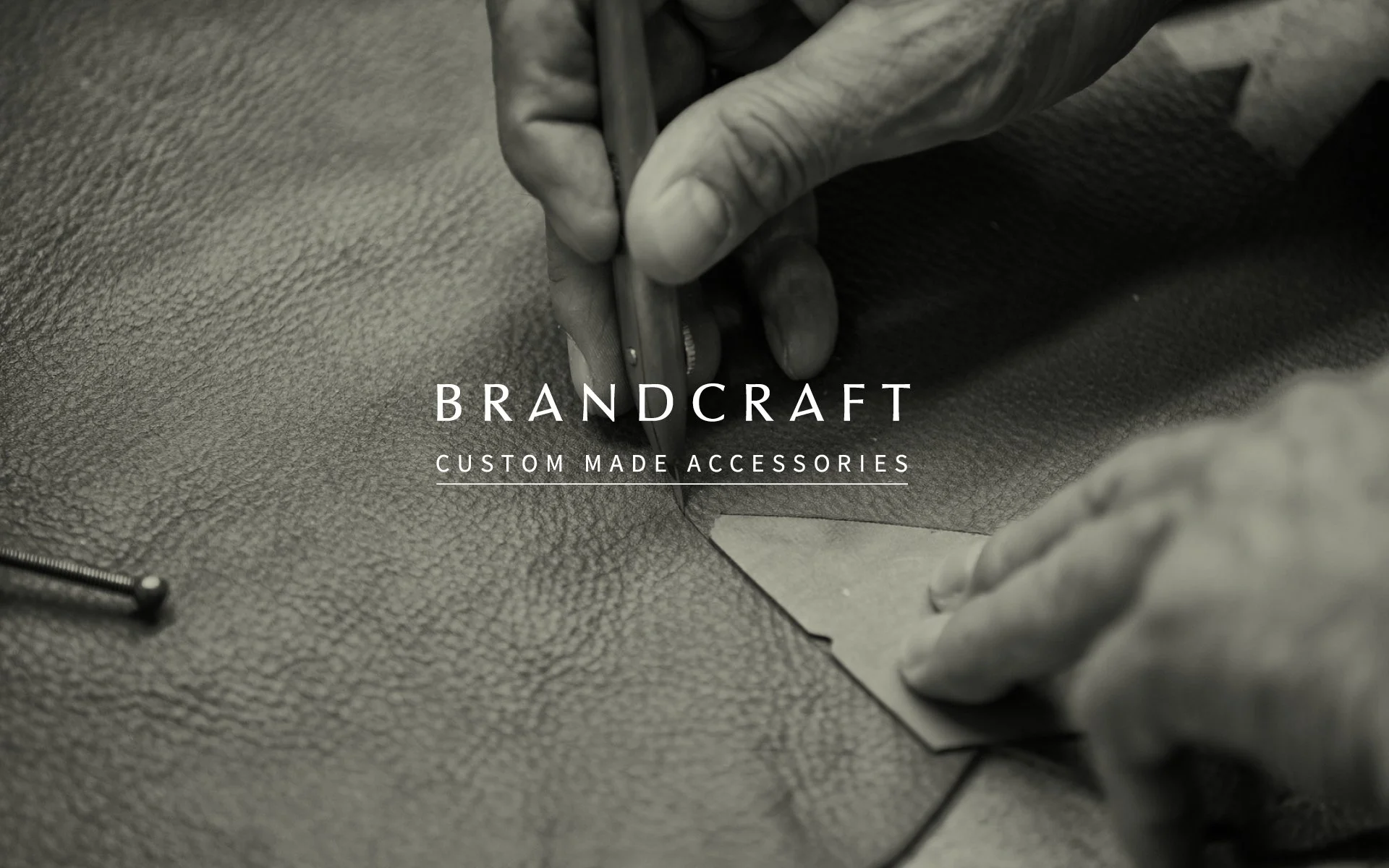 Hand arbeitet an einem maßgeschneiderten Accessoire aus Leder, sichtbare Handarbeit und Textur des Leders.