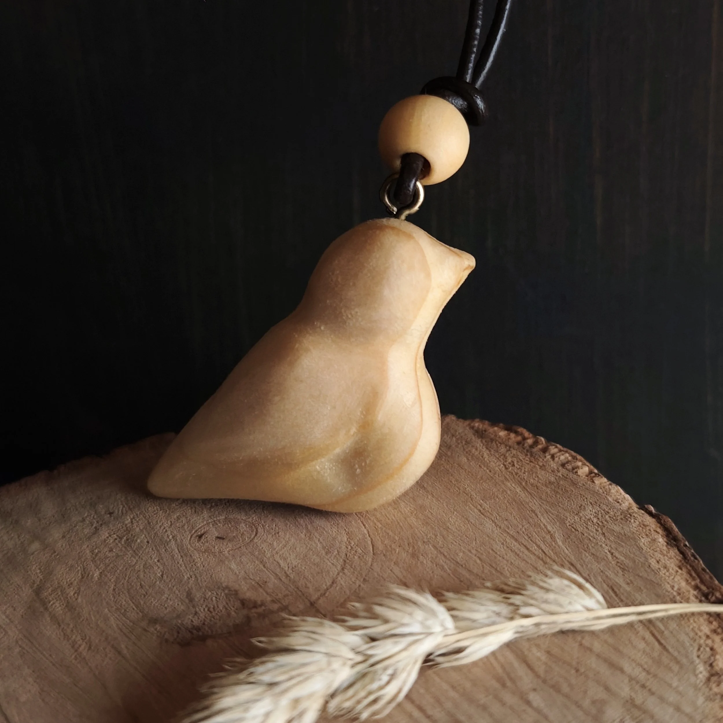 The Bird Who Stayed – hand‑carved natural Irish pine pendant