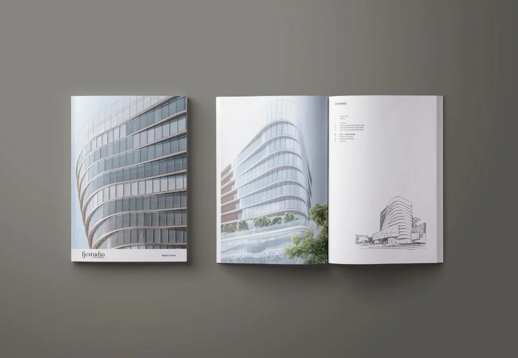 Open architecture portfolio book featuring modern building designs on a gray surface.
