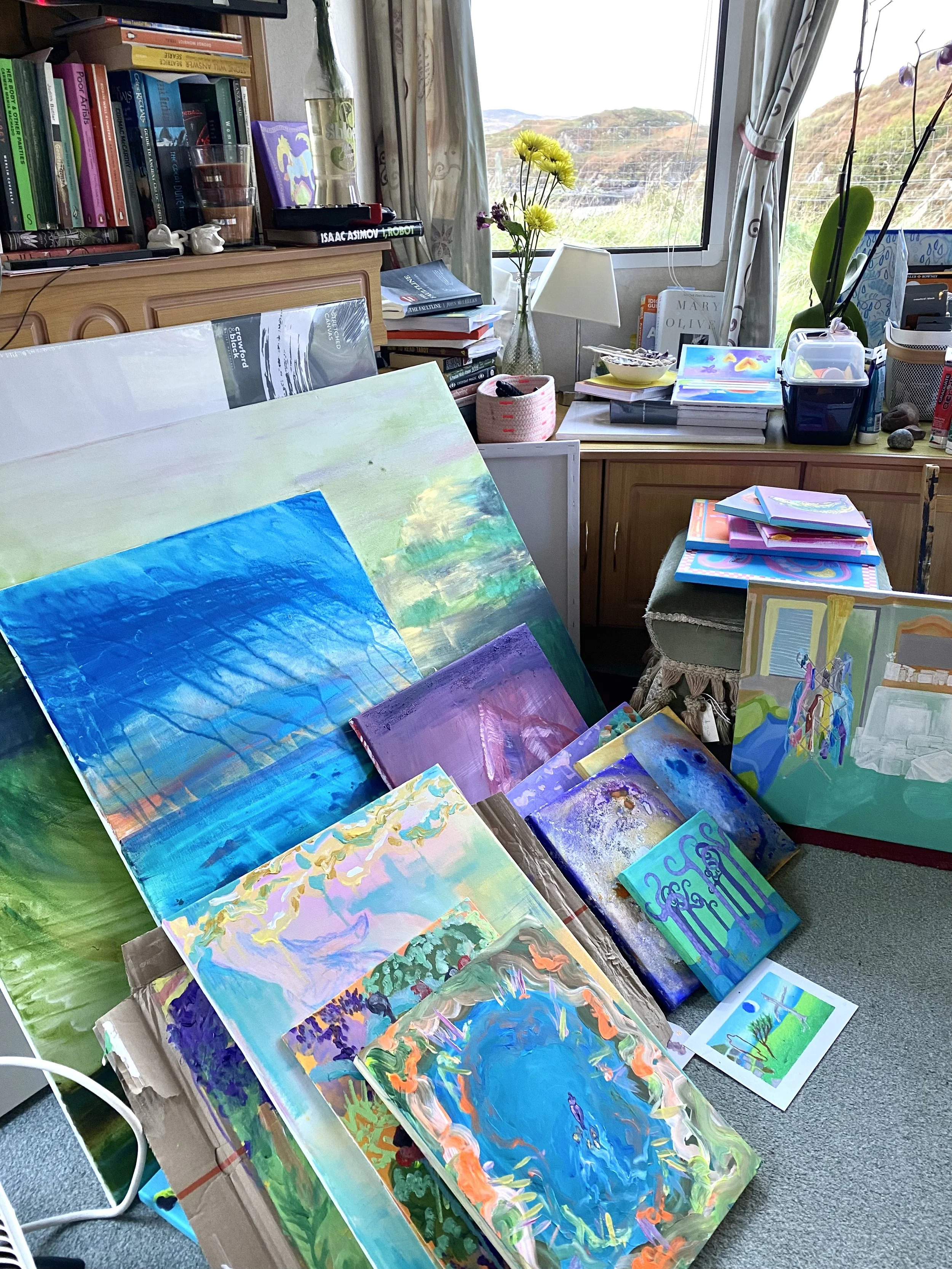 Bunch of canvases resting on each other in my living room studio