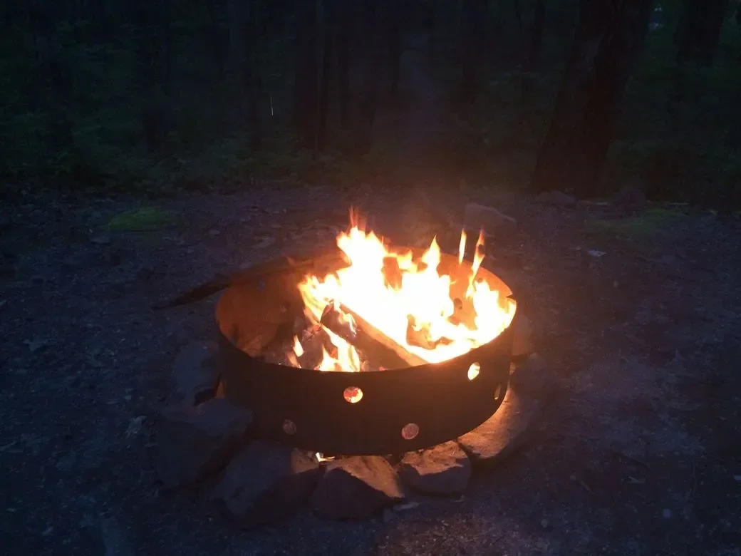 Campfire burning in a fire pit at night
