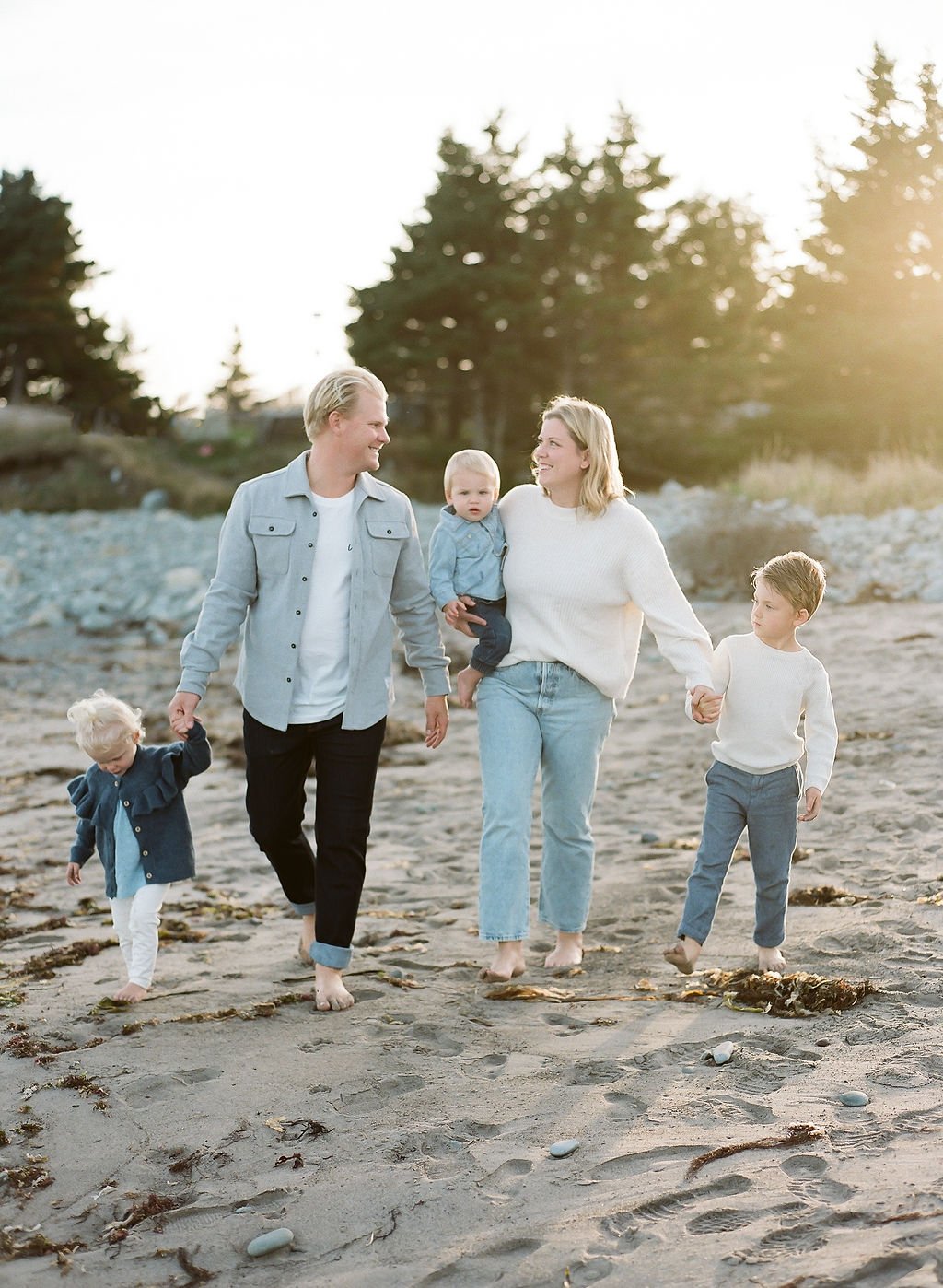 Family of five walking hand-in-hand on Lawrencetown beach at a Lawrencetown family session.